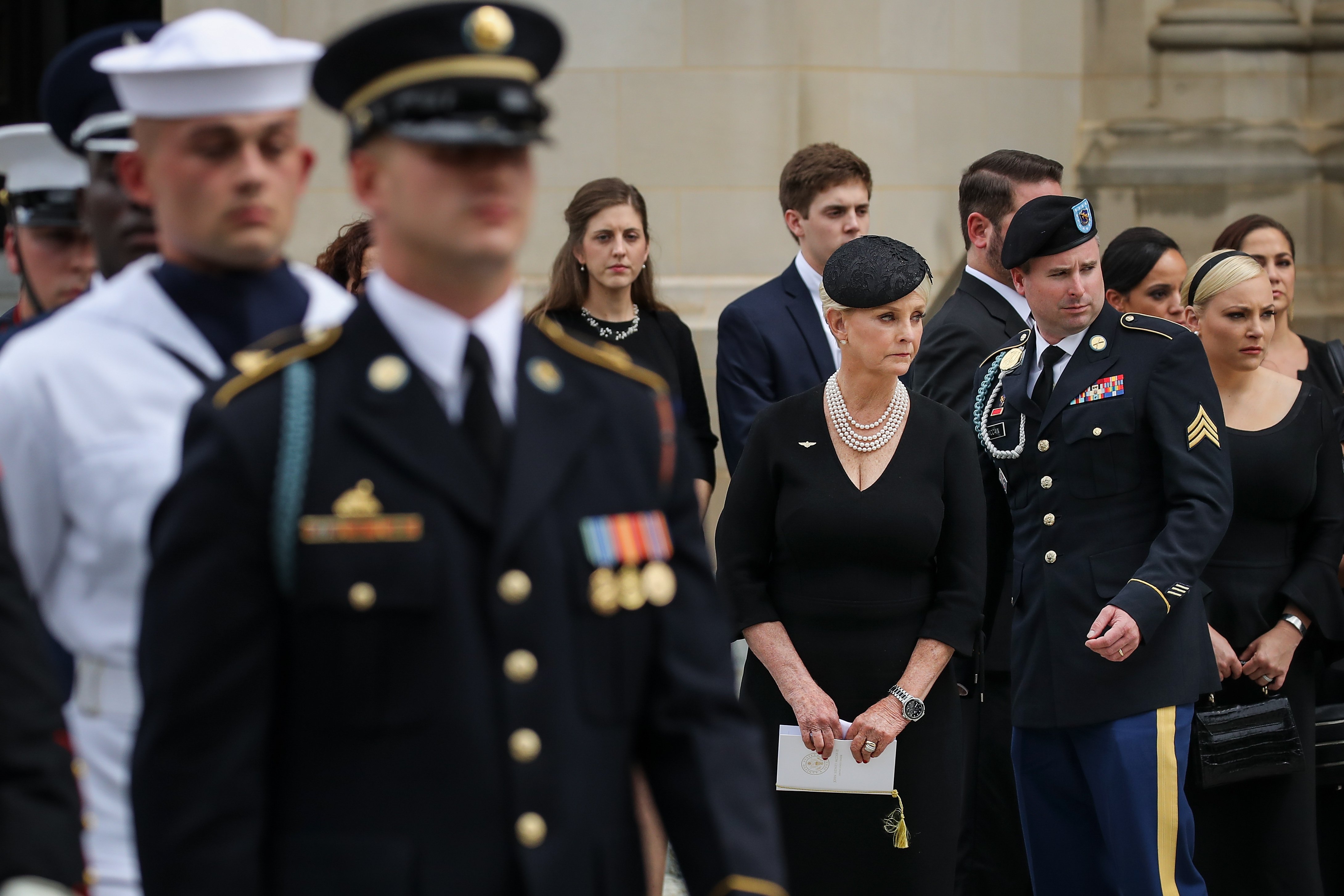 Cindy, James, and Meghan McCain look on as the casket of the late Senator John McCain is loaded into a Hearse at the Washington National Cathedral, September 1, 2018 in Washington, DC | Photo: Getty Images