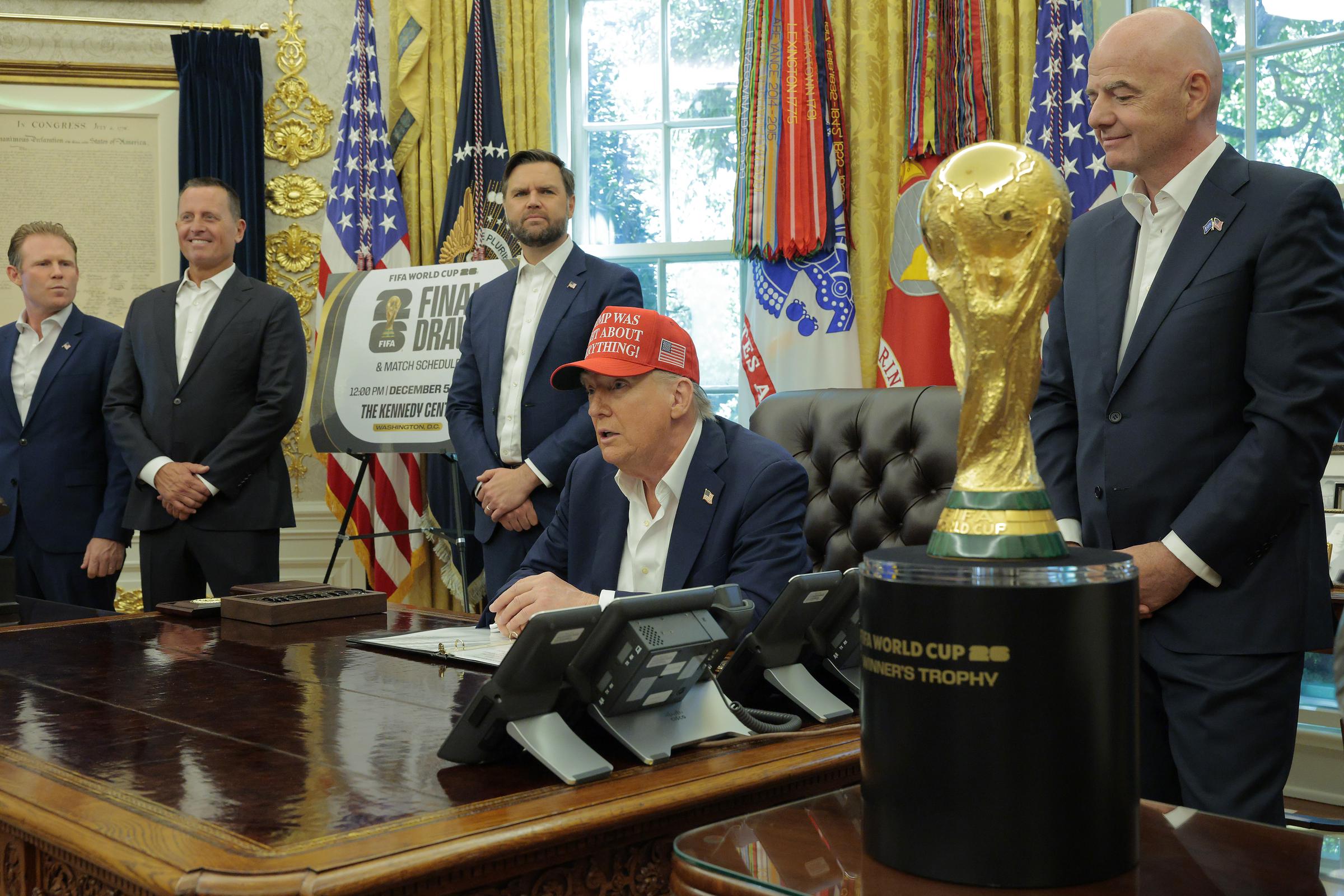 Donald Trump speaks in the Oval Office while FIFA President Gianni Infantino (R), and Vice President JD Vance (3rd L) look on August 22, 2025 in Washington, DC. | Source: Getty Images