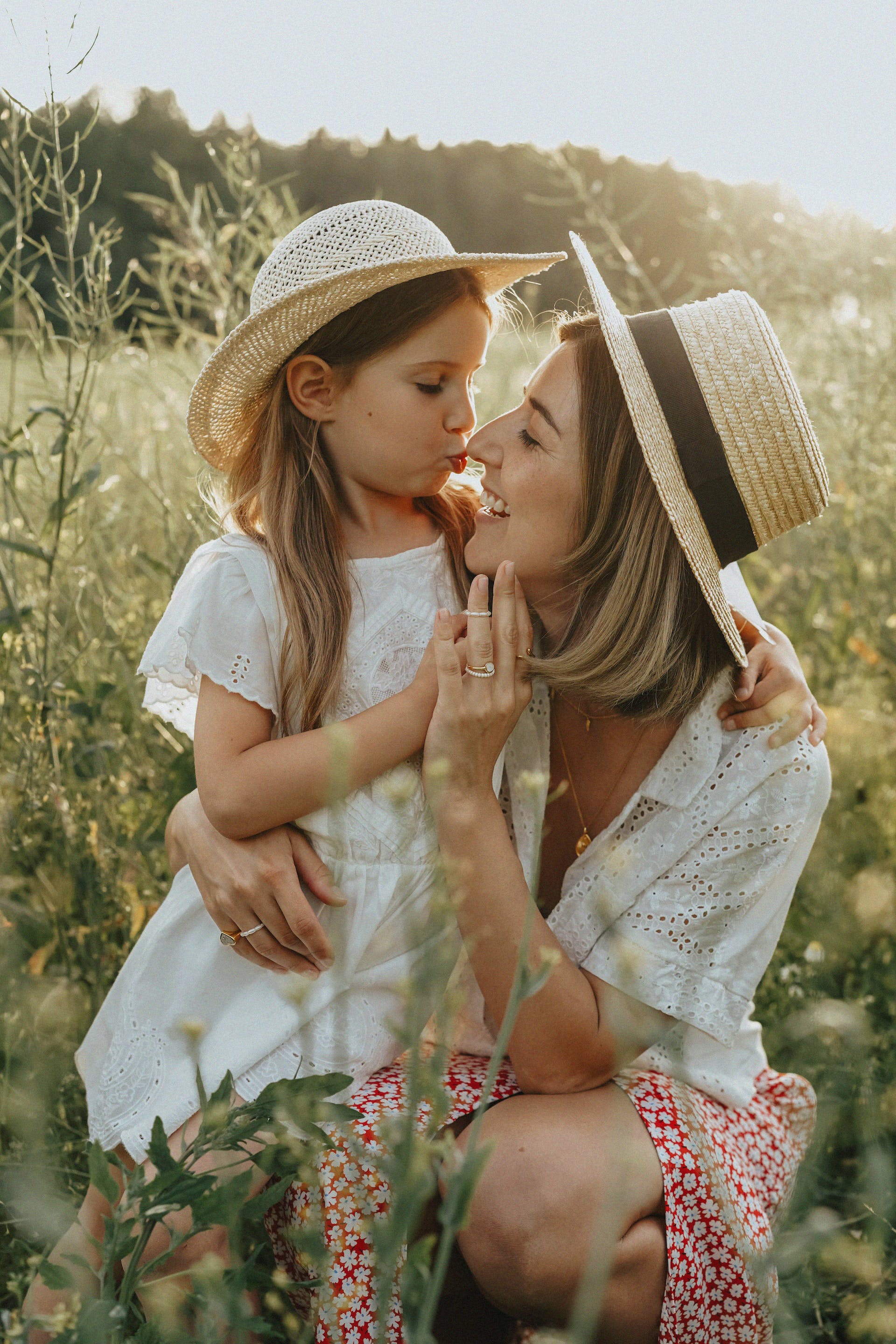 A young girl with her mother in a meadow | Source: Pexels