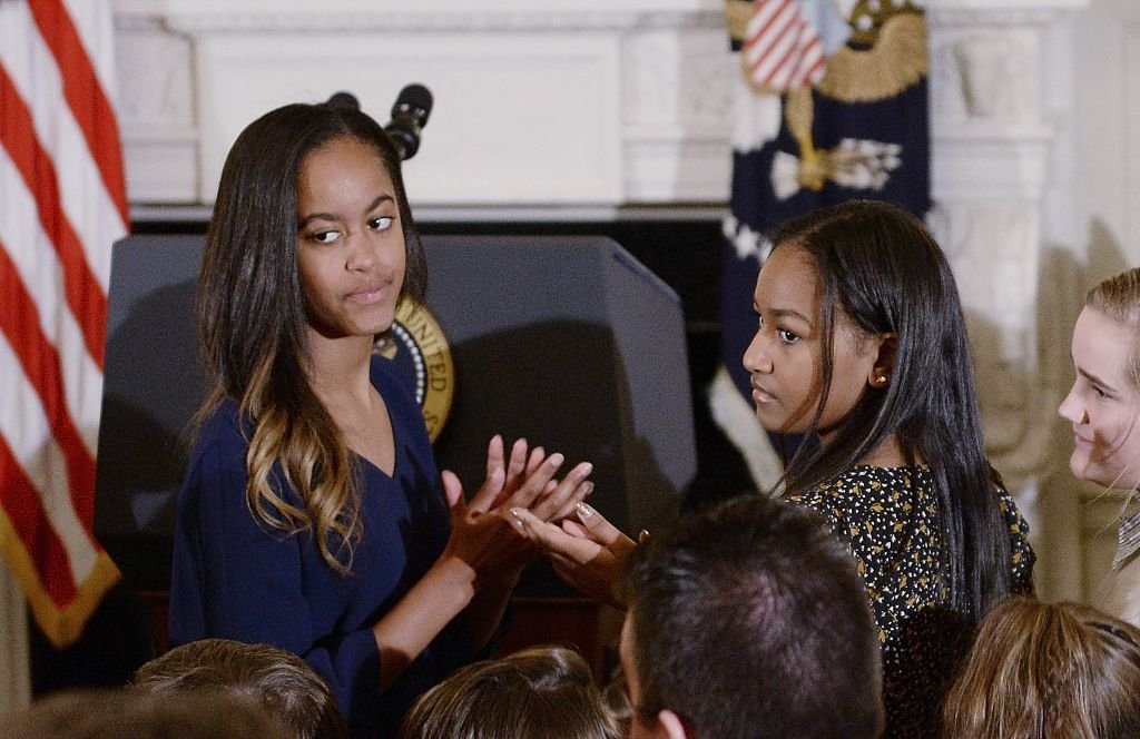 Malia and Sasha Obama look on during a ceremony presenting the Medal of Freedom to Vice-President Joe Biden at the State Dining room of the White House on January 12, 2017 in Washington, DC l Source: Getty Images 