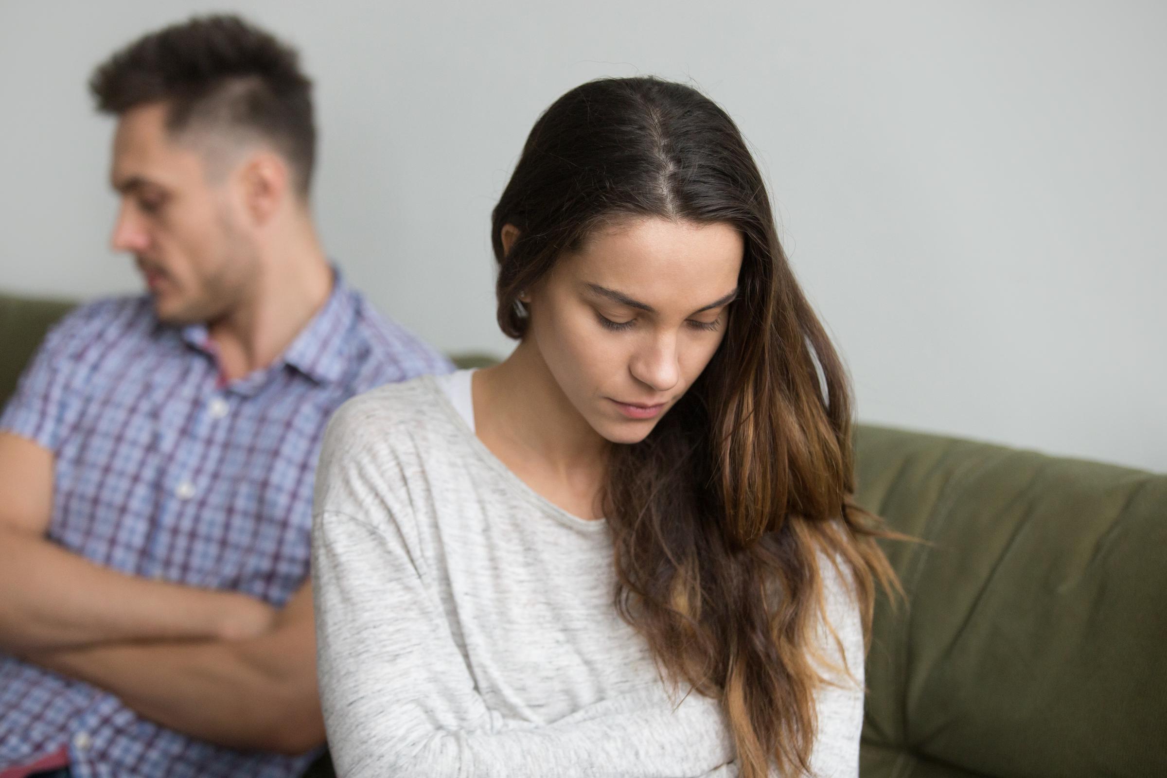 A sad woman looking away from her partner | Source: Freepik