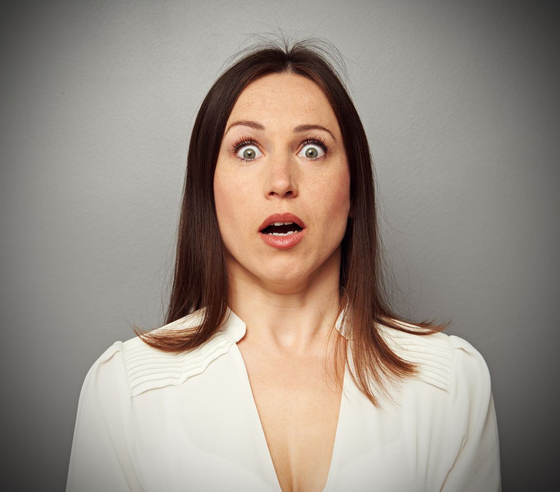 A woman shocked while looking at the camera. | Source: Shutterstock