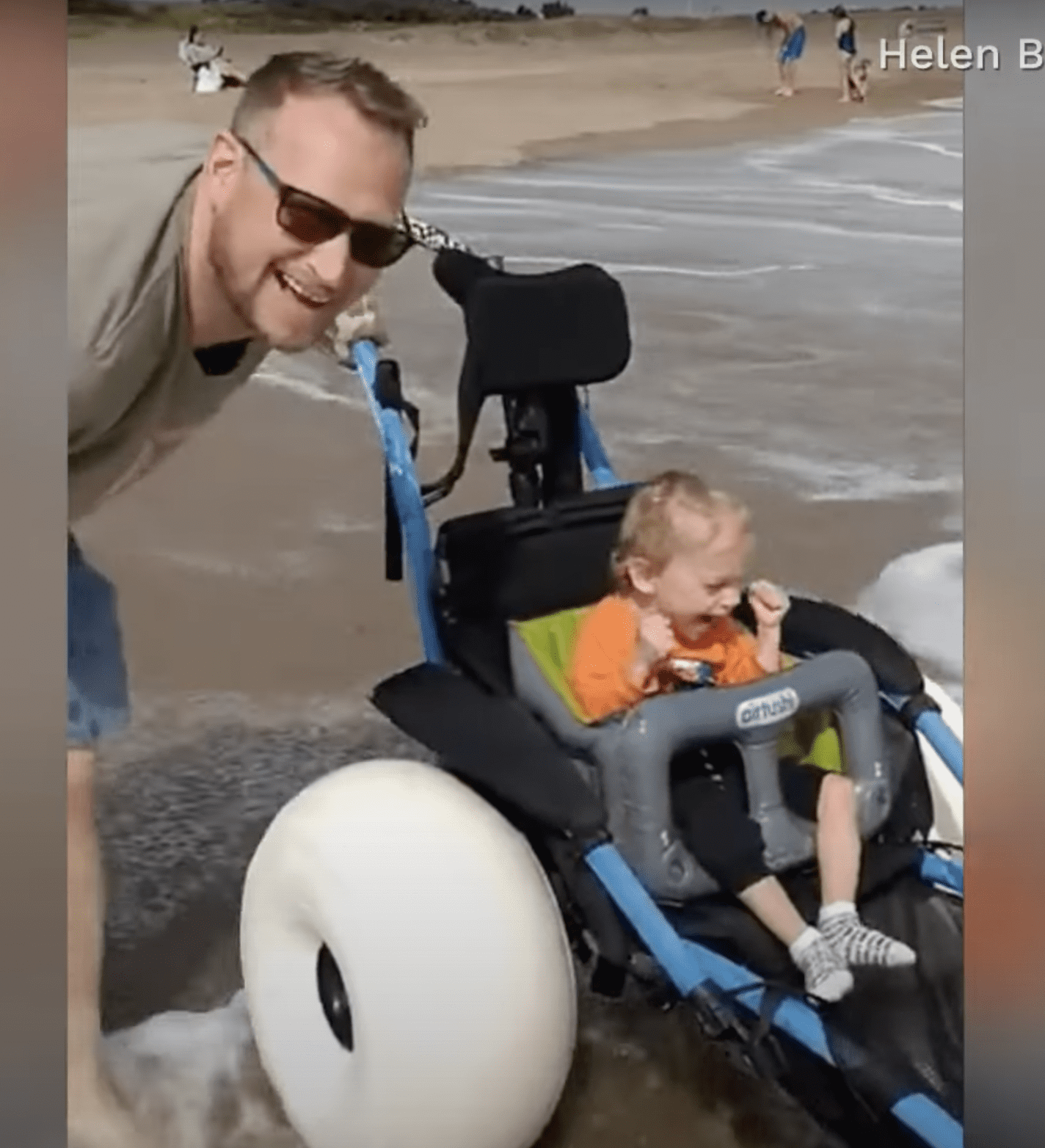 Joey Leathwood's father smiles after seeing his son having fun at the seaside. | Source: facebook.com/CBSNews