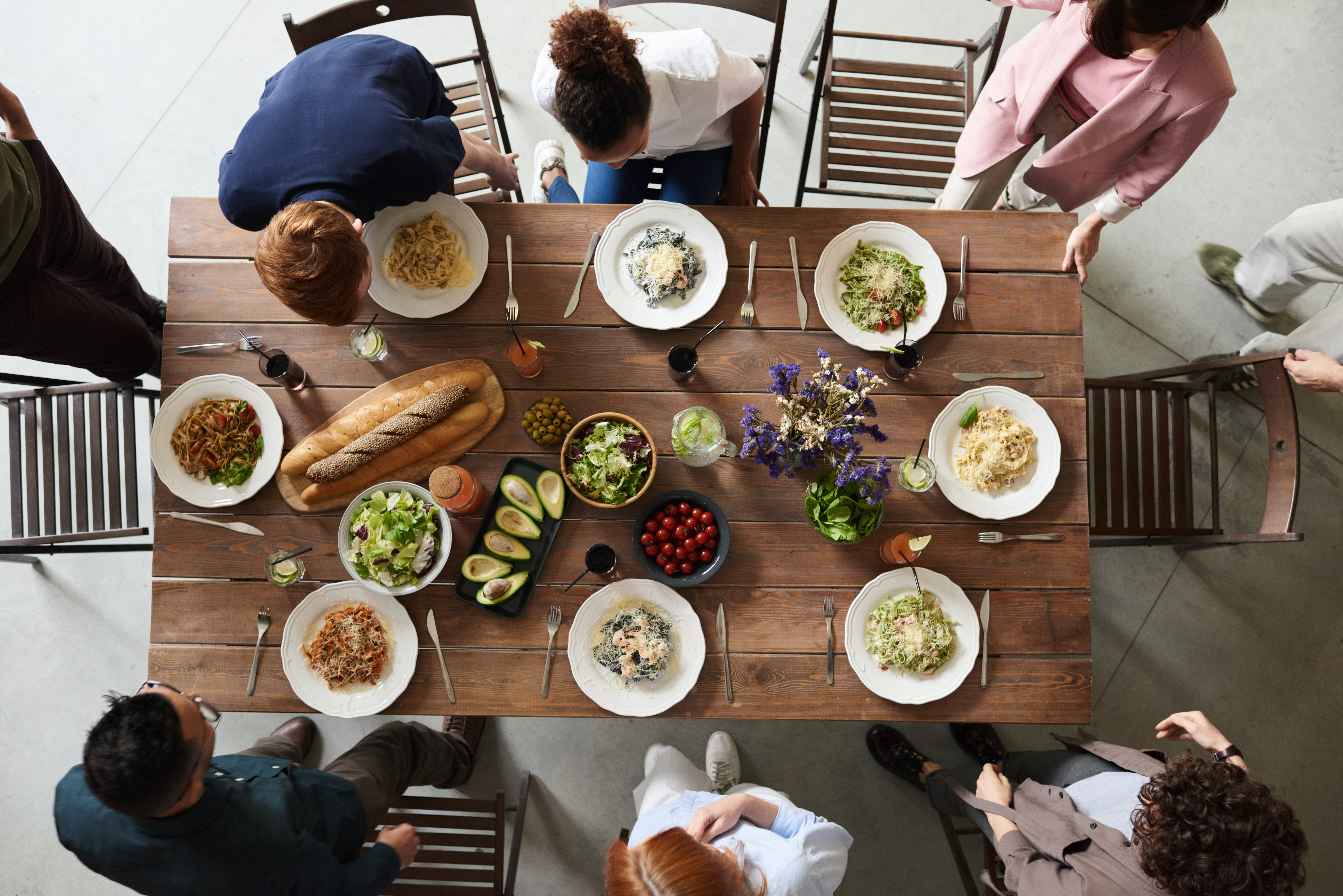 A group of people sitting down to enjoy a meal together | Source: Pexels