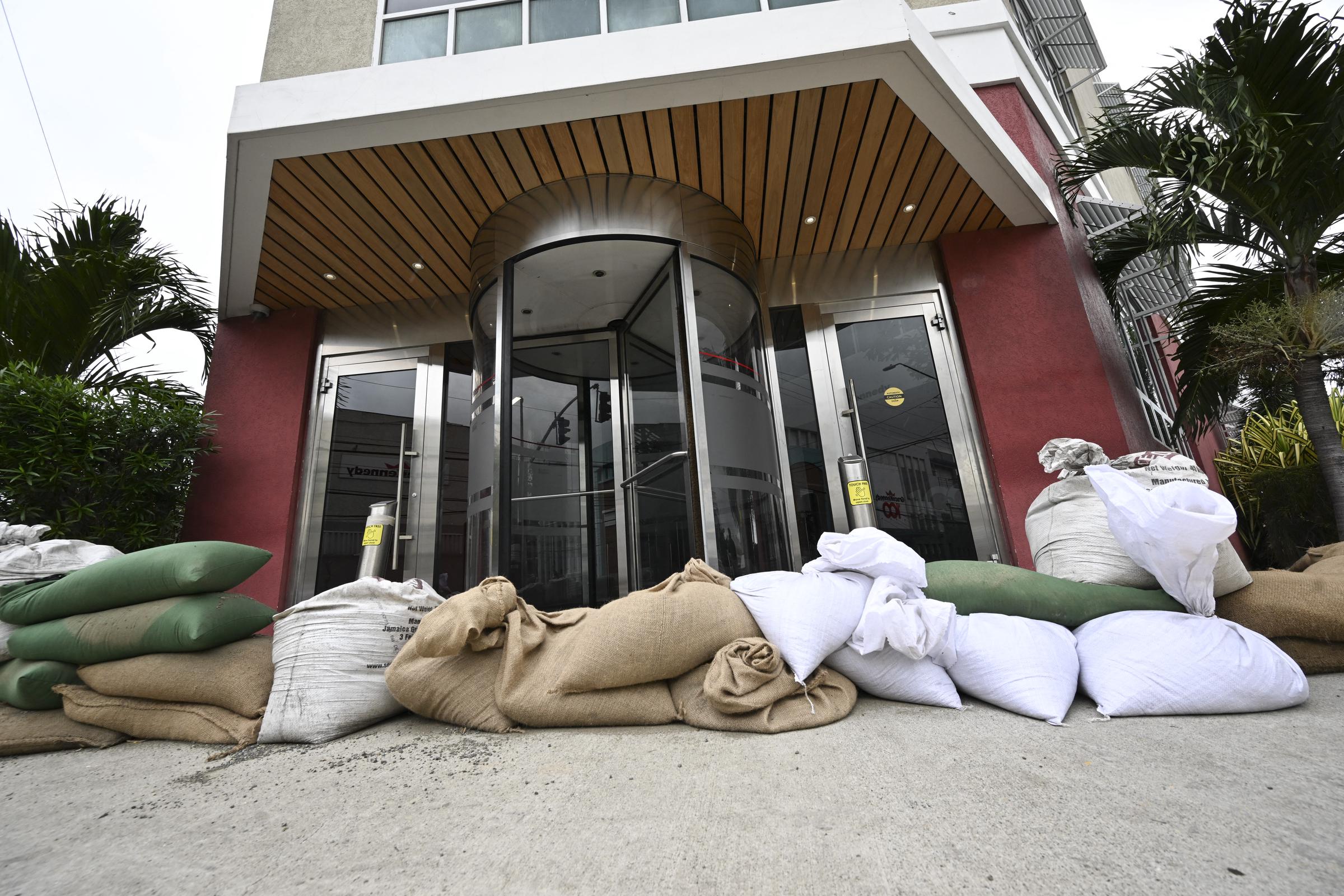 Sandbags are placed at the entrance of the Grace Kennedy building in preparation for the arrival of Hurricane Melissa in downtown Kingston, Jamaica, on October 25, 2025 | Source: Getty Images