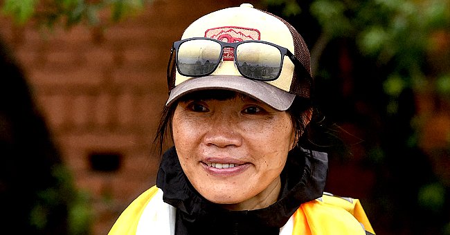 Hong Kong teacher Tsang Yin-hung, the fastest female Everest climber, pictured wearing a cap and yellow raincoat. | Photo: Getty Images