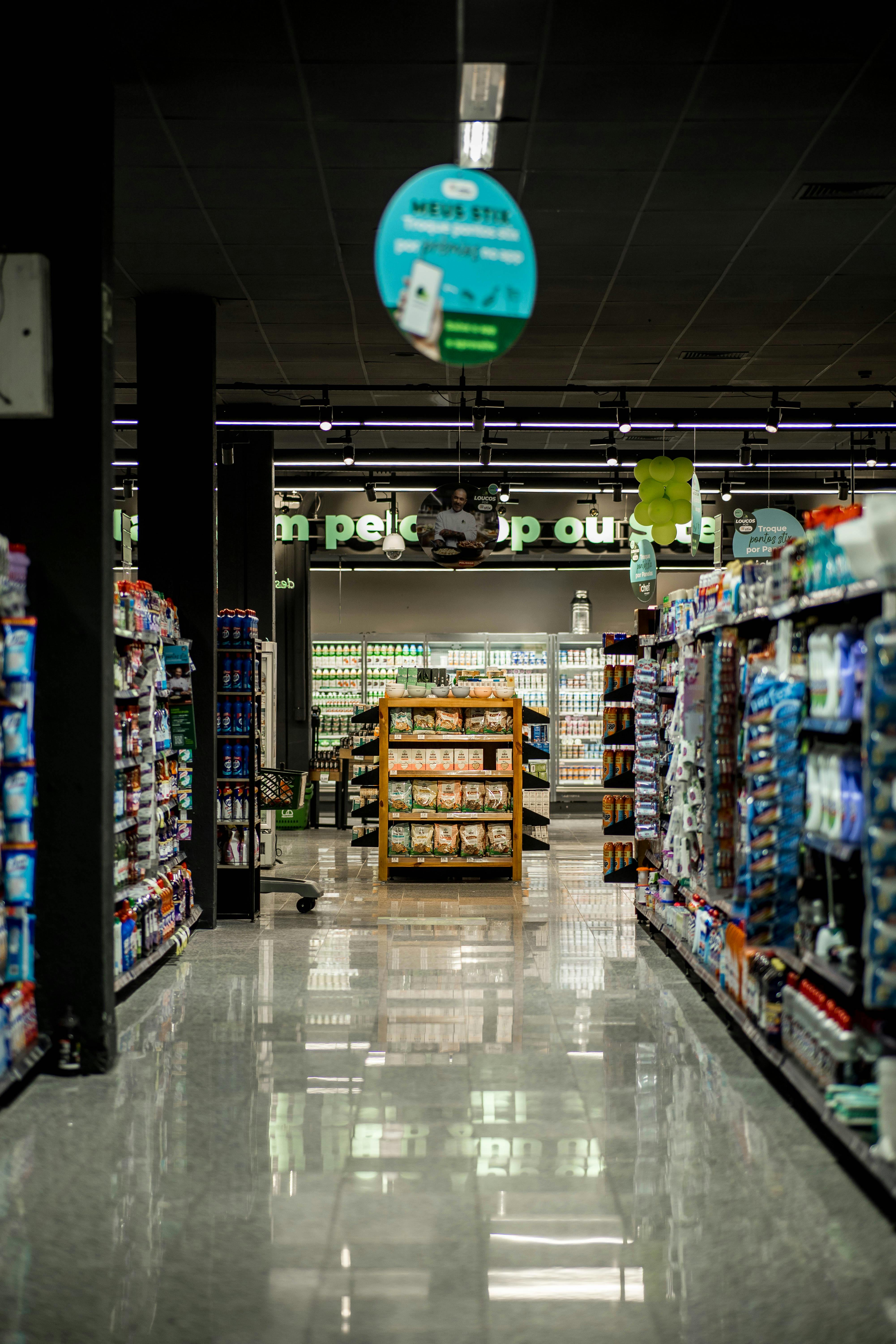 A quiet supermarket aisle stretches into the distance. | Source: Pexels