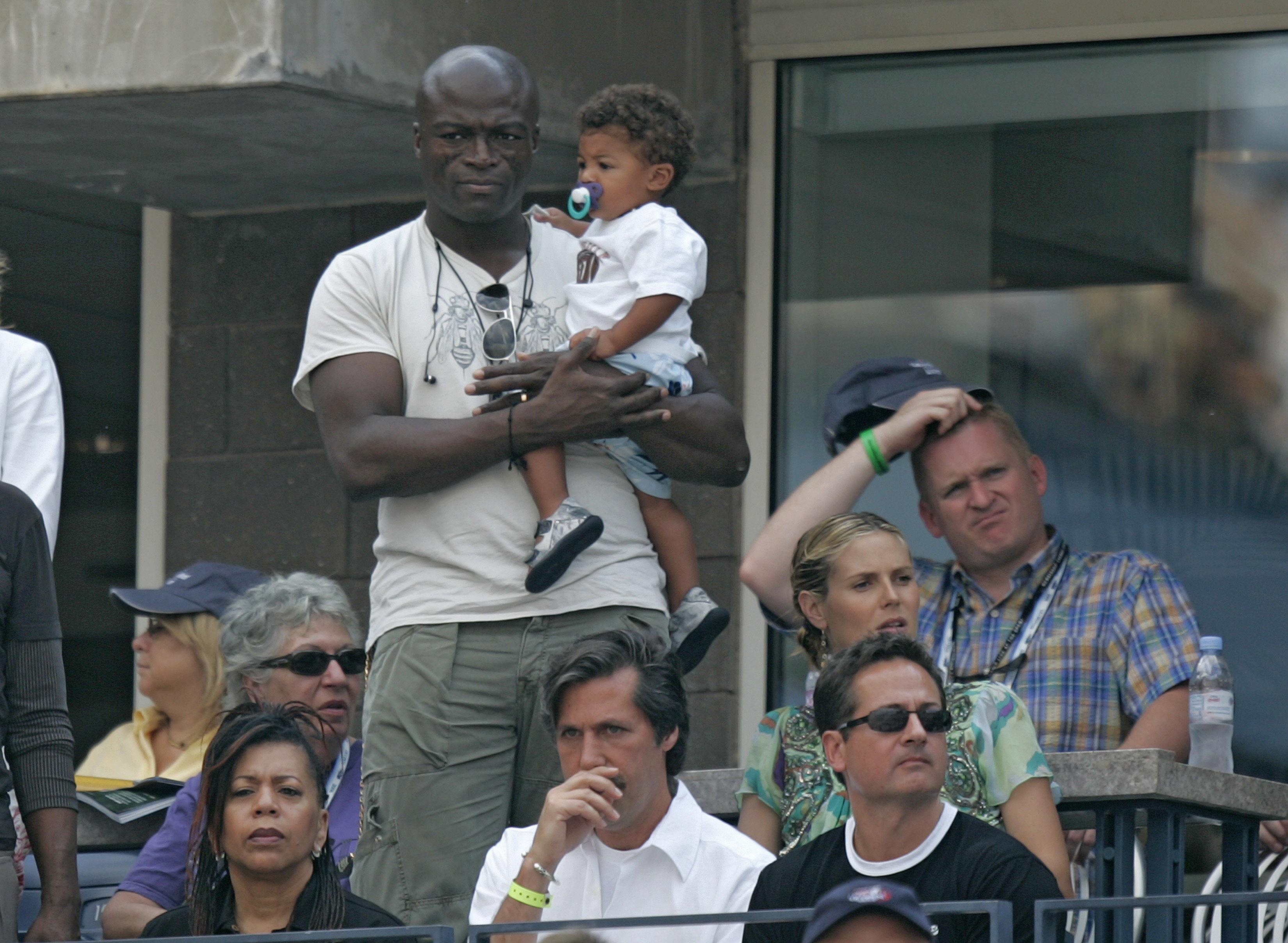 Seal holding his son Henry Samuel at a 2006 US Open game on September 8, in Flushing Meadows, Queens, New York. | Source: Getty Images