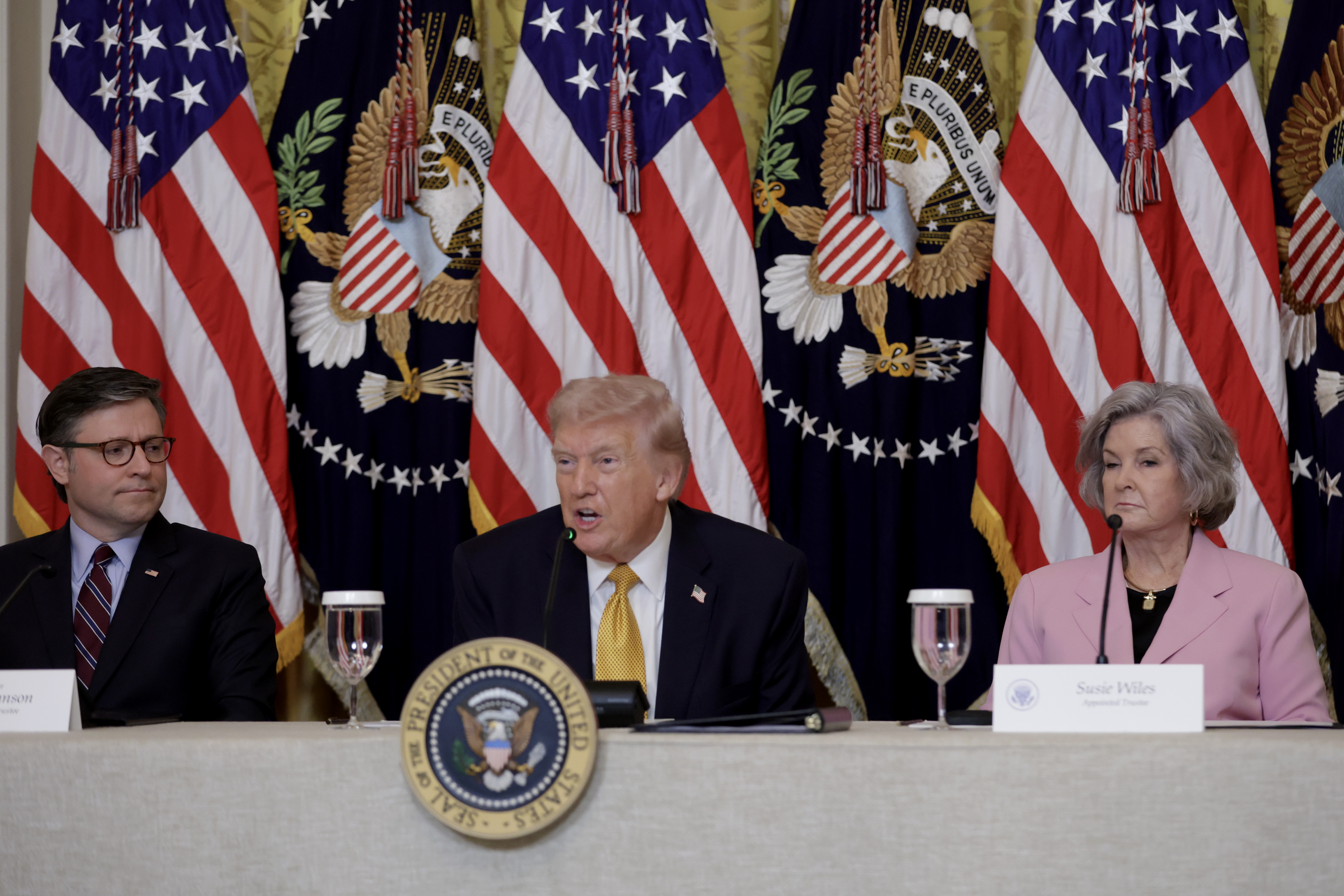 President Donald Trump sits with U.S. Speaker of the House Mike Johnson and White House Chief of Staff Susie Wiles during a lunch with the Trump Kennedy Center Board Members on March 16, 2026 in Washington, DC. | Source: Getty Images