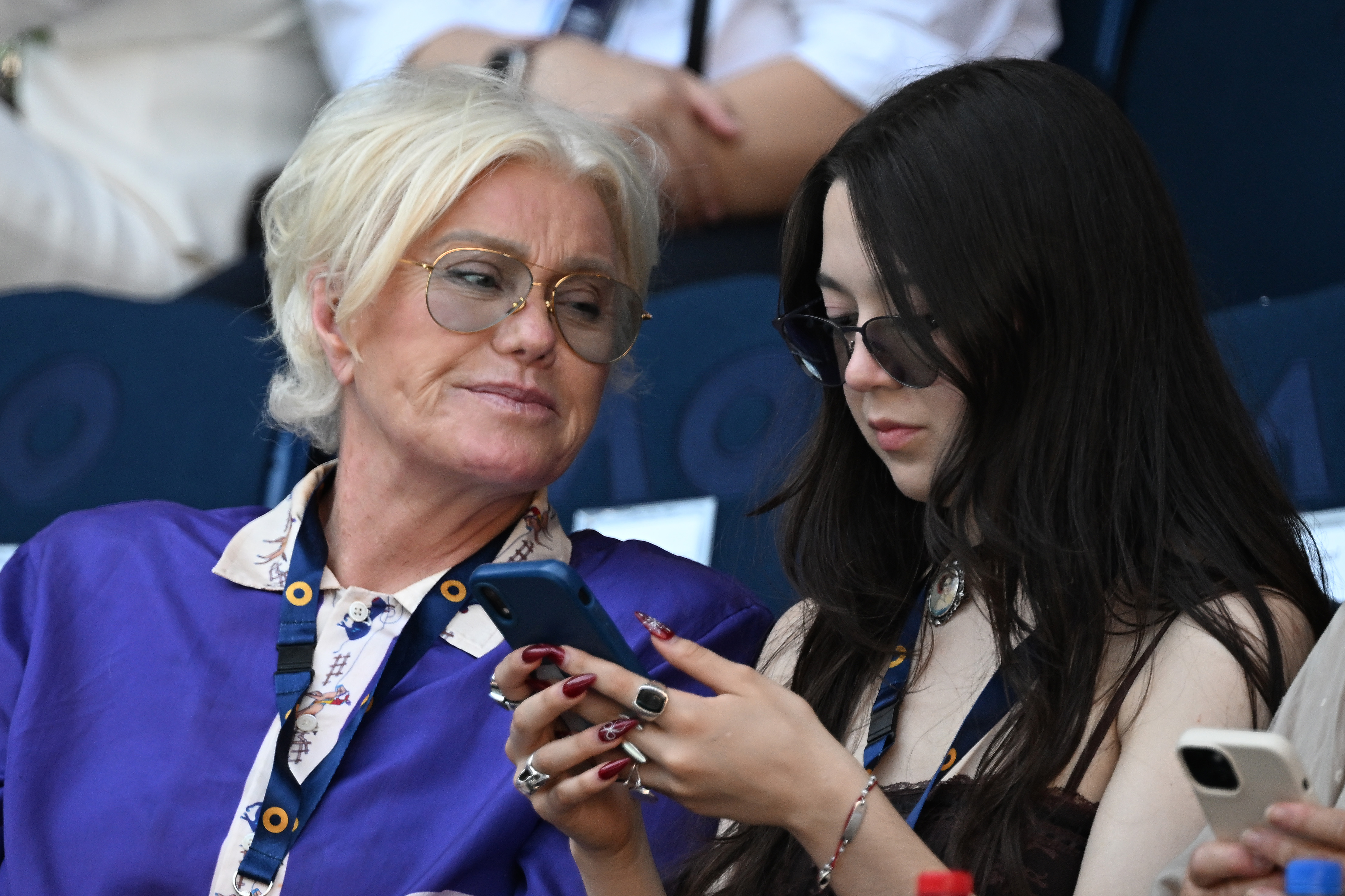 Deborra-Lee Furness watches her daughter Ava Eliot Jackman using her phone during their appearance at the 2025 Australian Open on January 14, 2025, in Melbourne, Australia | Source: Getty Images