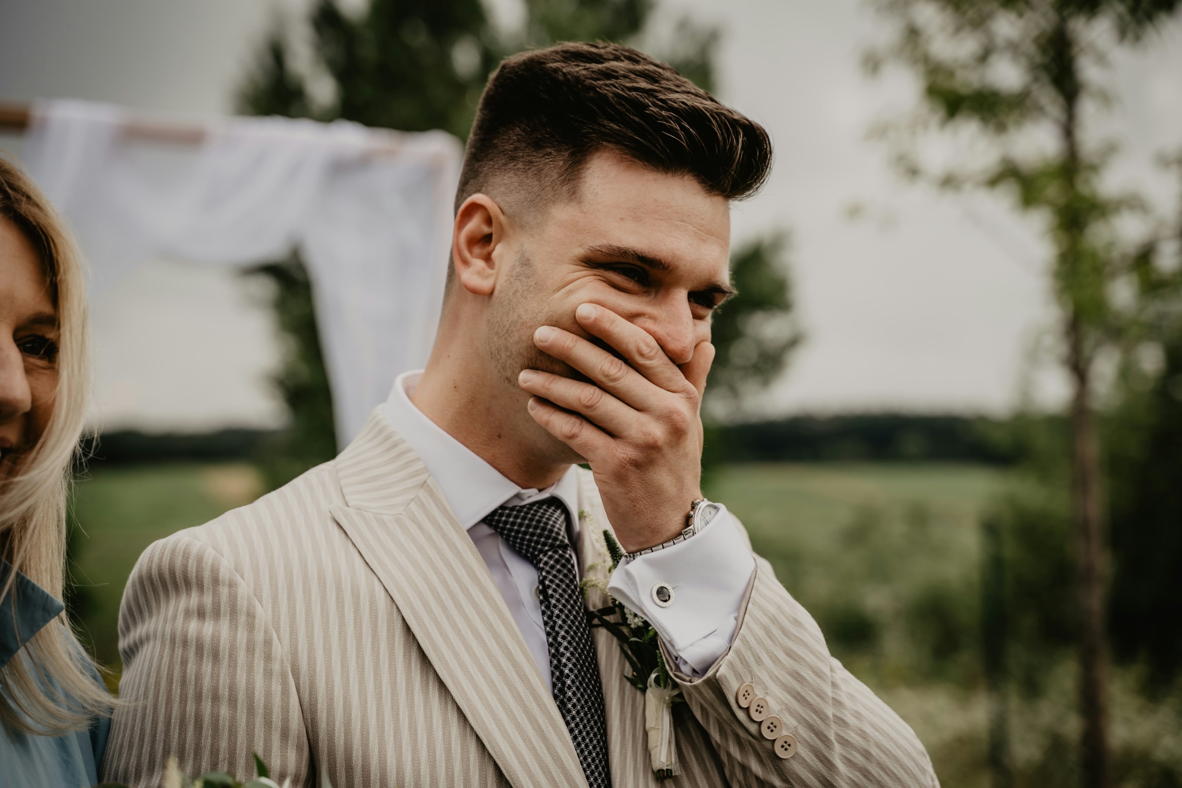 A groom trying to suppress his laughter | Source: Unsplash