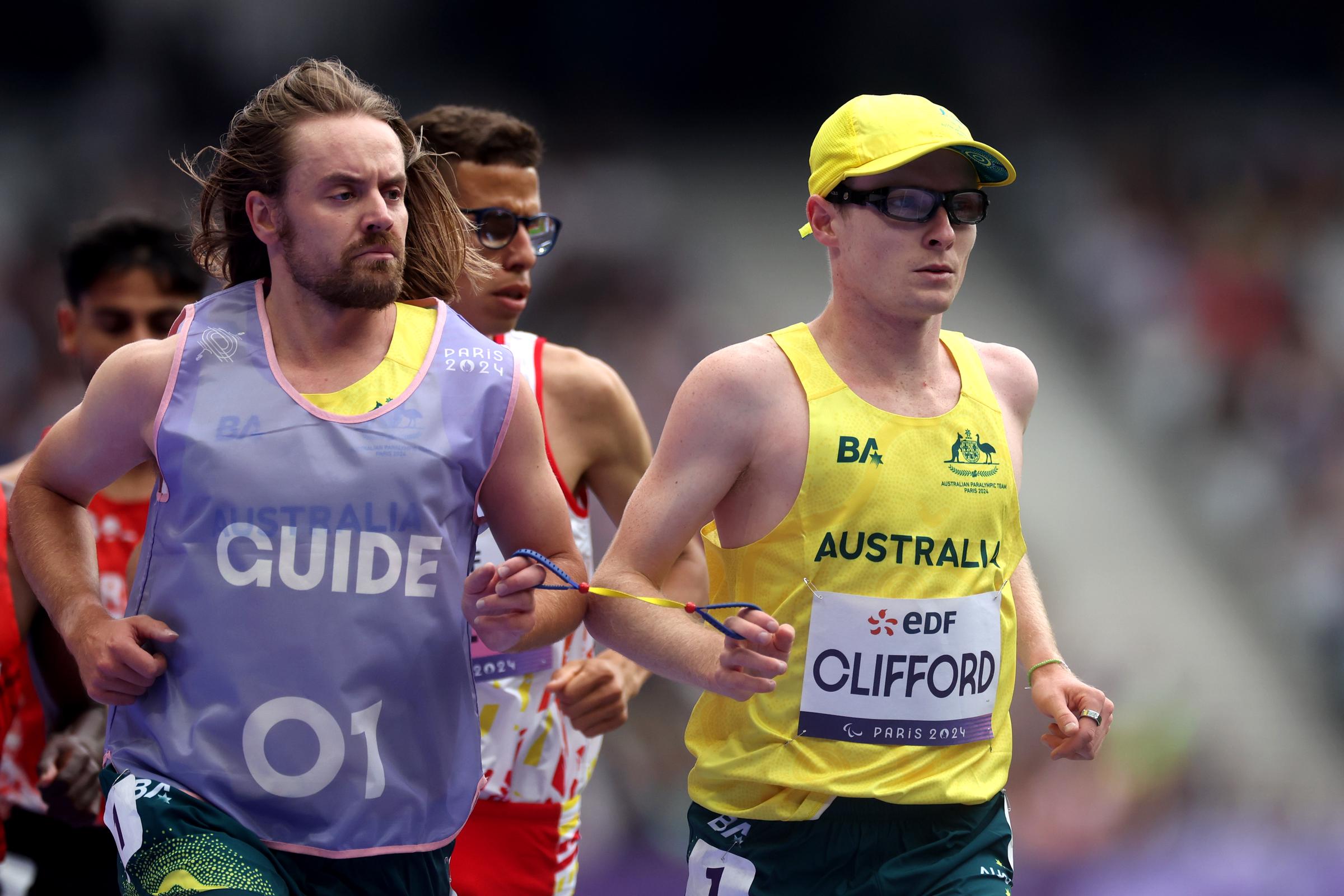 Jaryd Clifford and his guide Tim Logan during the Men's 5,000 m T13 Final at the Paris 2024 Summer Paralympic Games in Paris, France on August 31, 2024 | Source: Getty Images