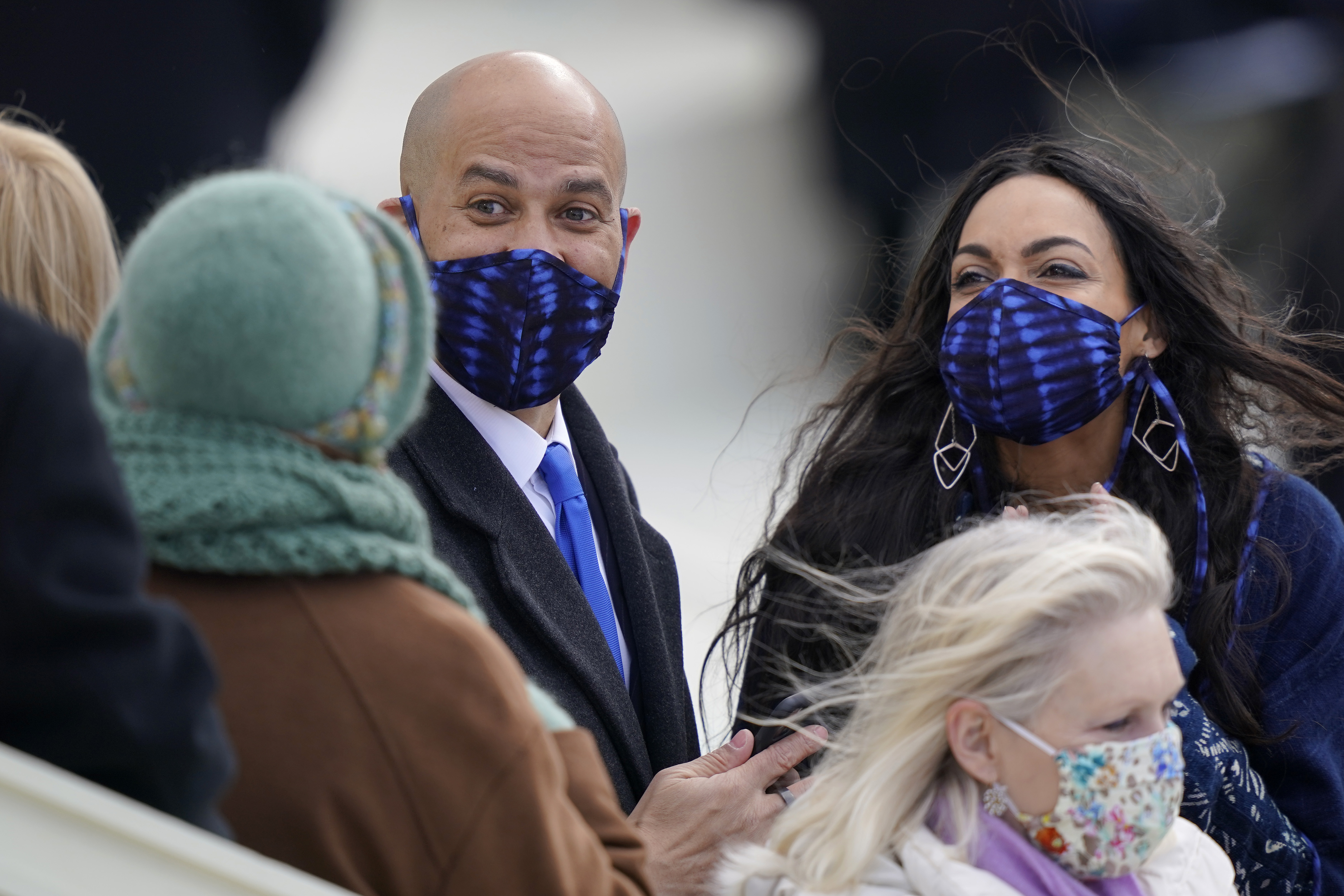 Senator Cory Booker and Rosario Dawson arrive at the U.S. Capitol for the presidential inauguration, bundled in coordinated masks and sharing a moment of quiet excitement amid the historic occasion.