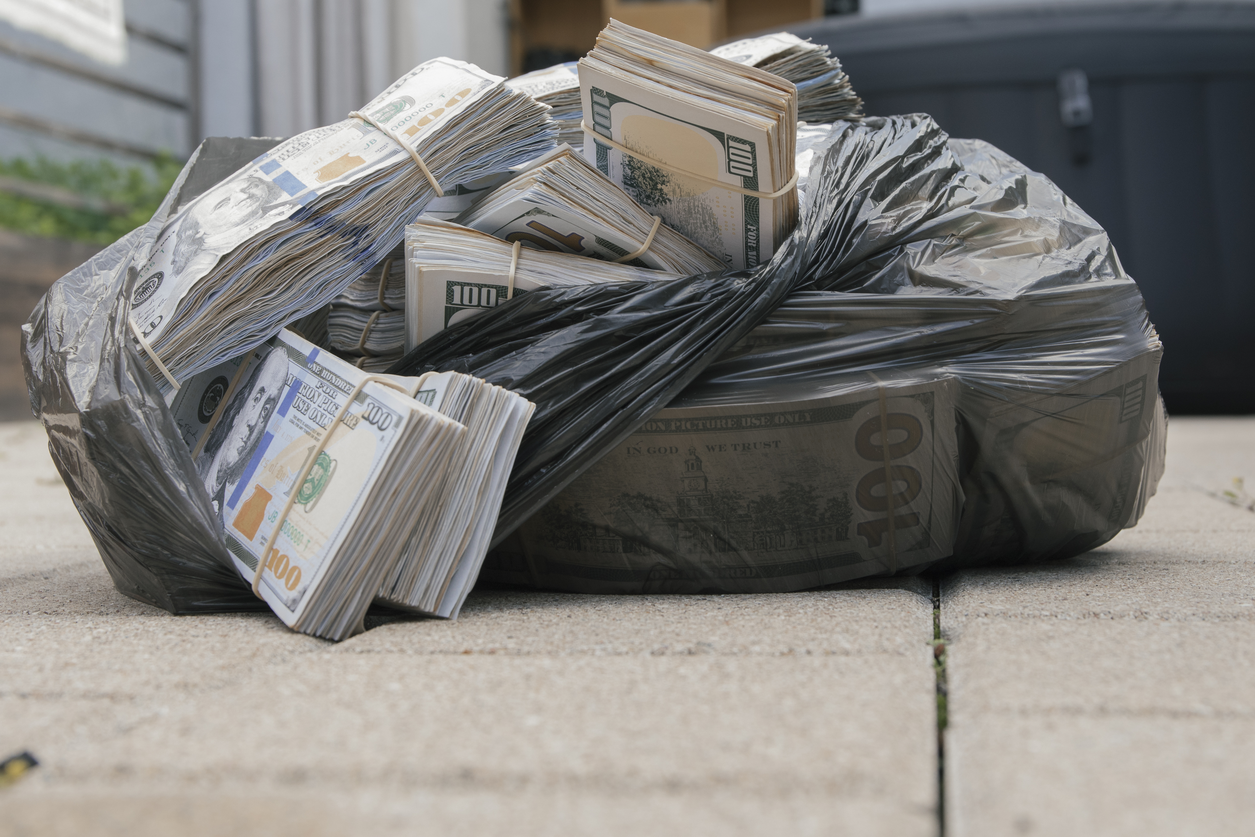 Lots of money in plastic bag | Source: Shutterstock.com