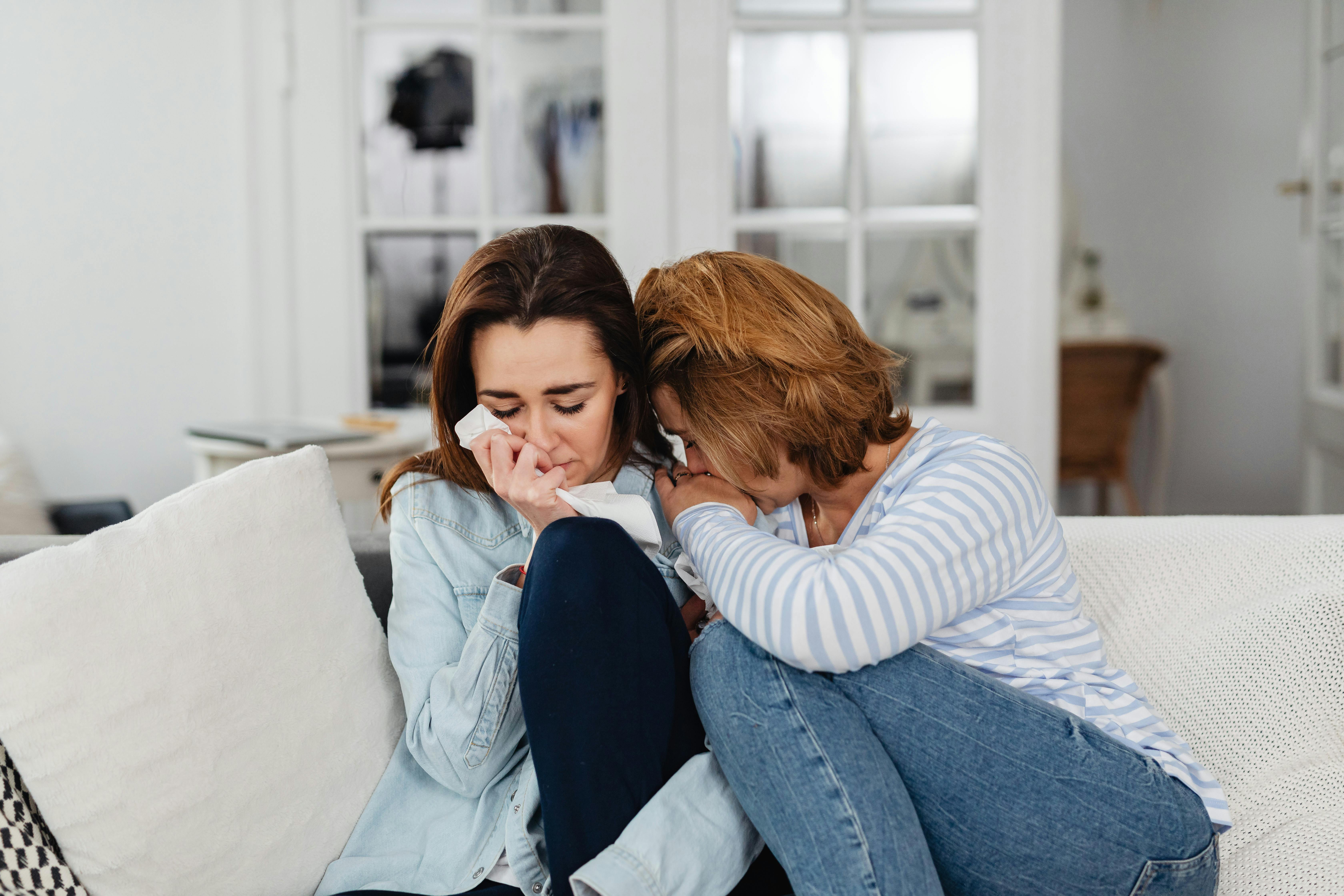 An emotional woman being comforted by a friend | Source: Pexels