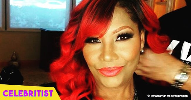 Traci Braxton, 46, defies her age flaunting red braids with matching, red lipstick in new video