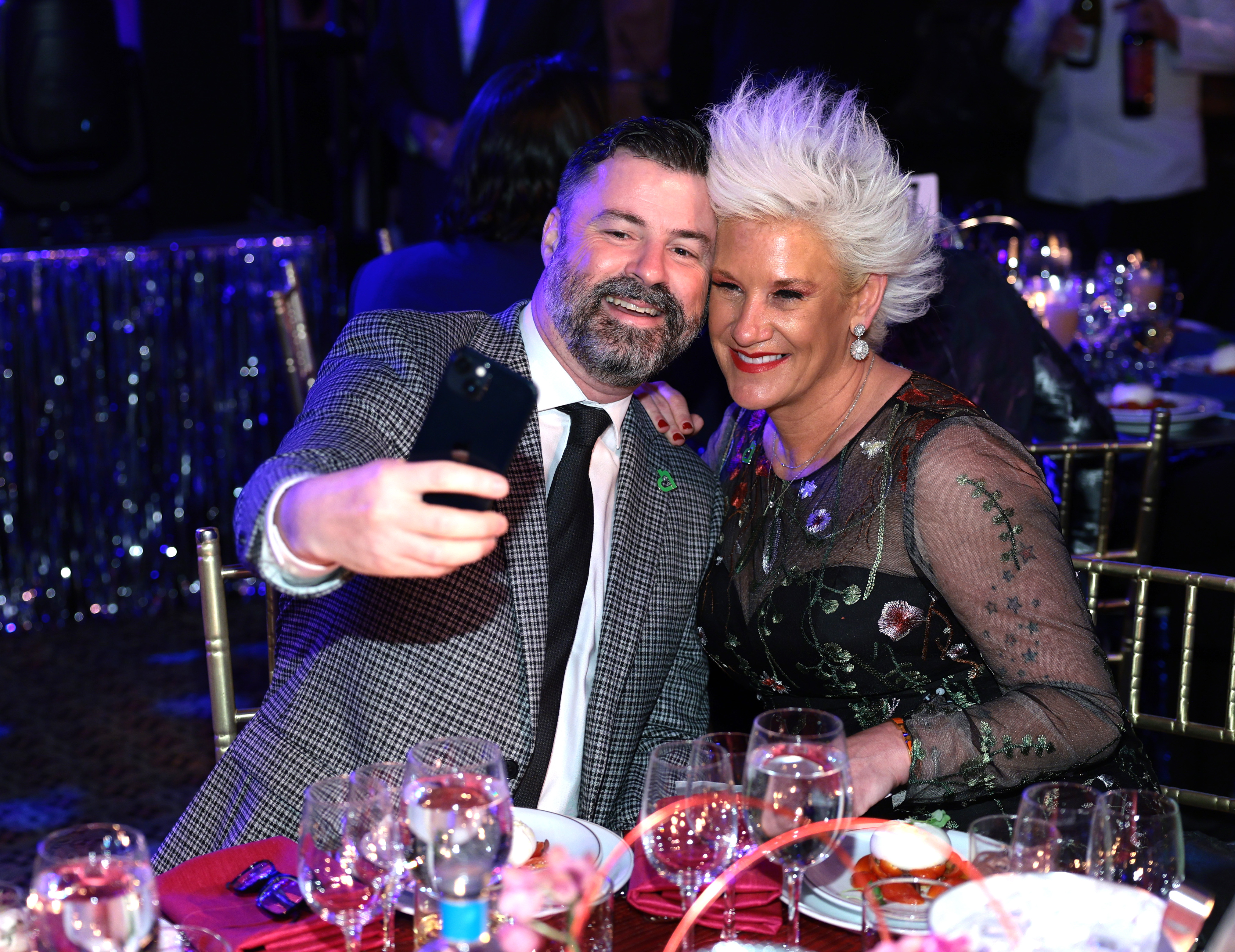 Anne Burrell and Stuart Claxton cozying up for a photo during City Harvest's 40th Anniversary Gala at Cipriani 42nd Street on April 25, 2023, in New York City. | Source: Getty Images