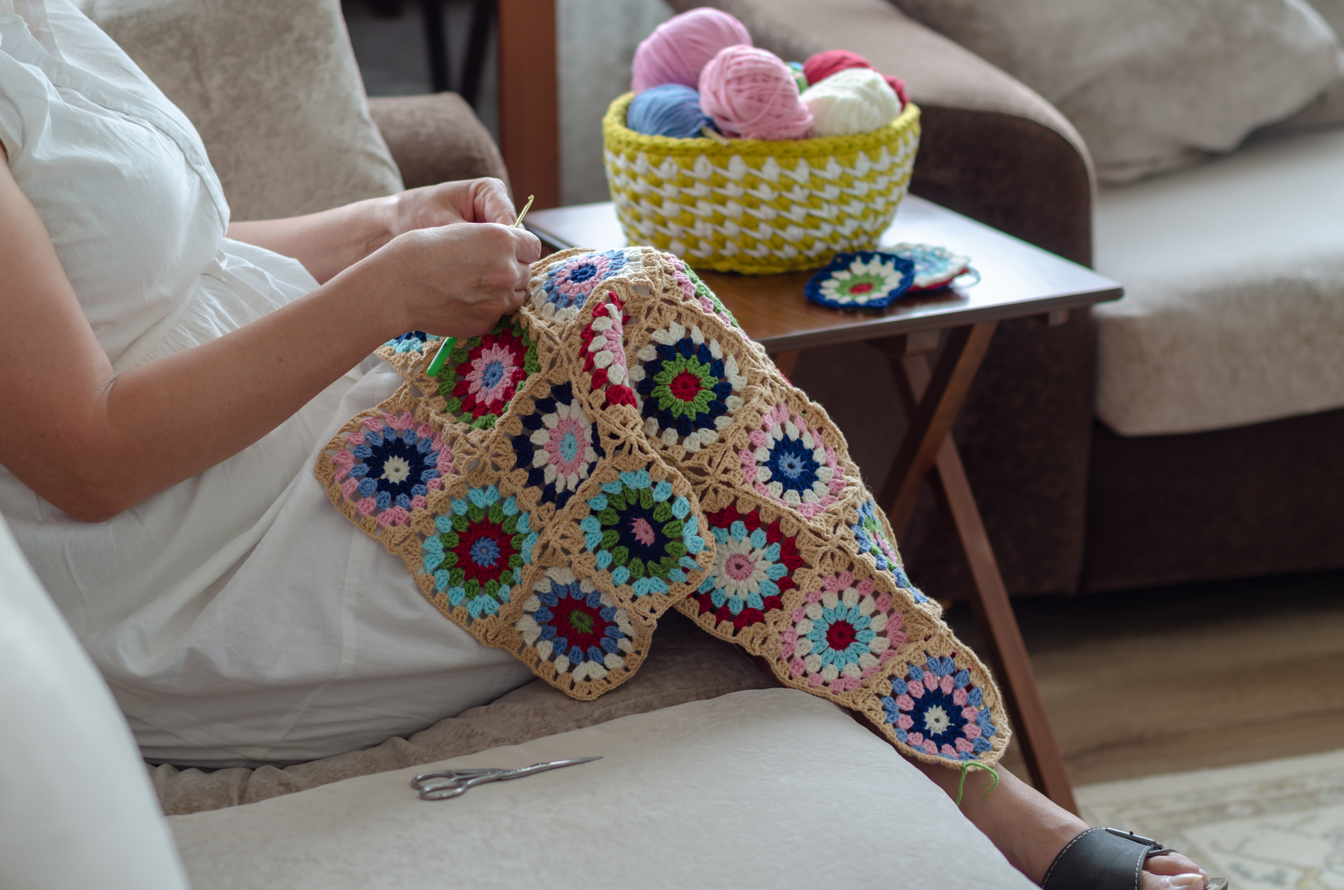 Woman crocheting a baby blanket | Source: Shutterstock