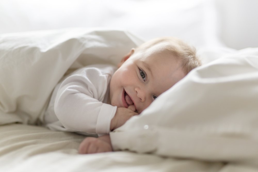 Une petite fille couchée sur un lit. | Photo : Shutterstock