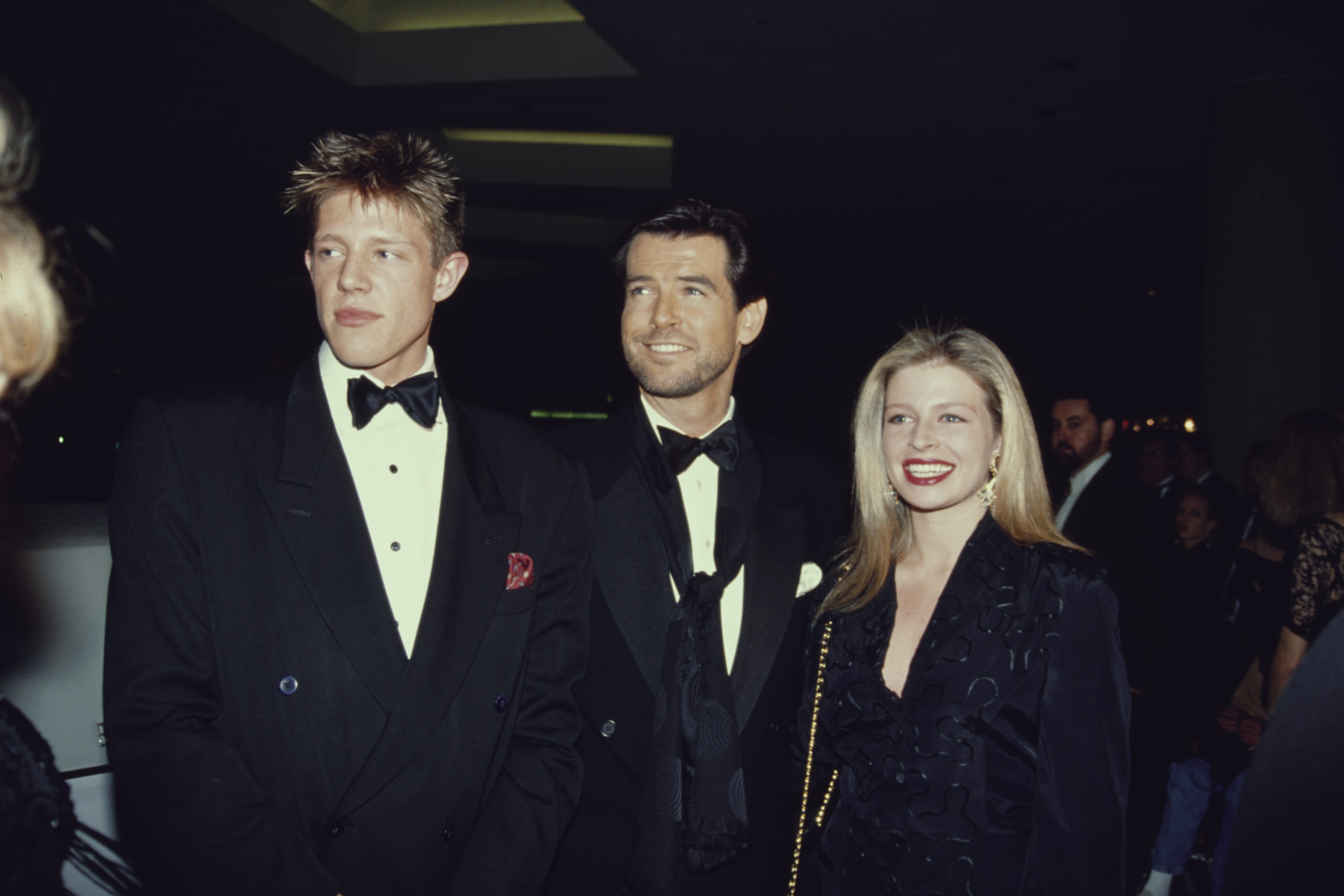 Irish actor Pierce Brosnan with his adopted children Christopher Harris and Charlotte Harris, at the Beverly Hilton Hotel in Beverly Hills, California, 18th January 1992. | Source: Getty Images