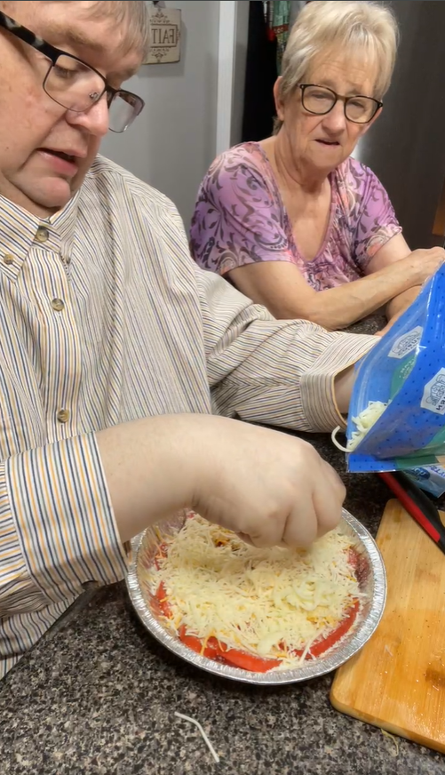 Frances stayed by her son's side throughout the livestream as he added cheese on top of the sliced tomatoes. Their conversations and shared moments became a familiar part of the show for many viewers. | Source: Facebook/coffeetimewithjohnandmomma