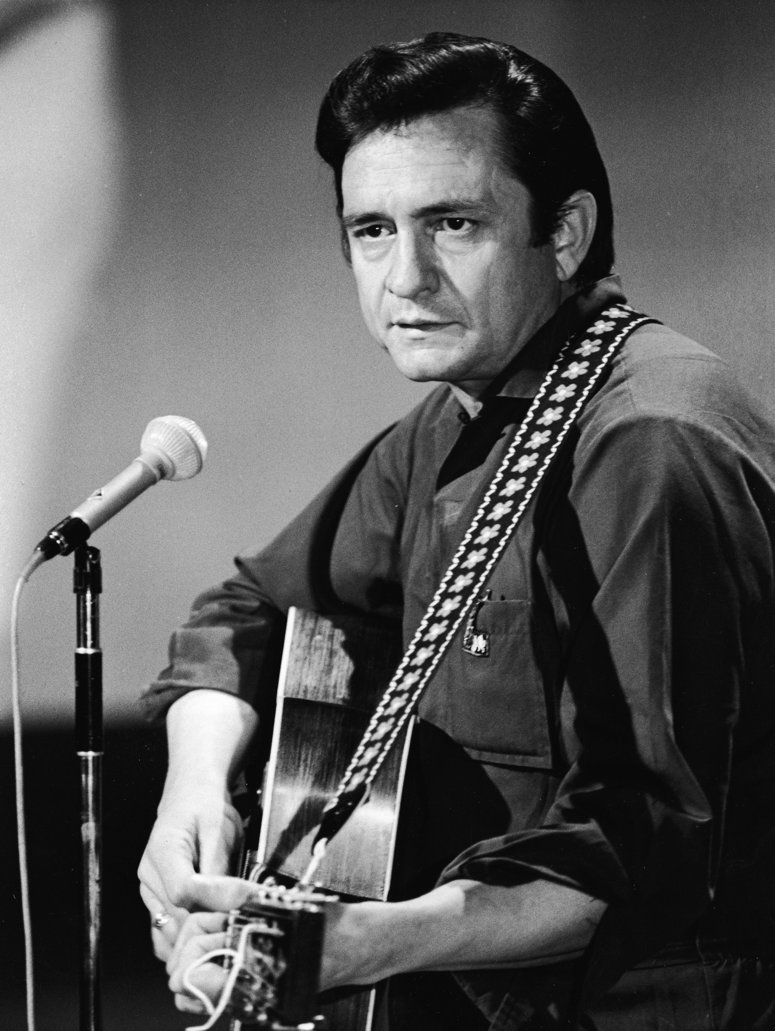 Johnny Cash playing the guitar in a still from his television variety series, 'The Johnny Cash Show,' circa 1968 | Source: Getty Images