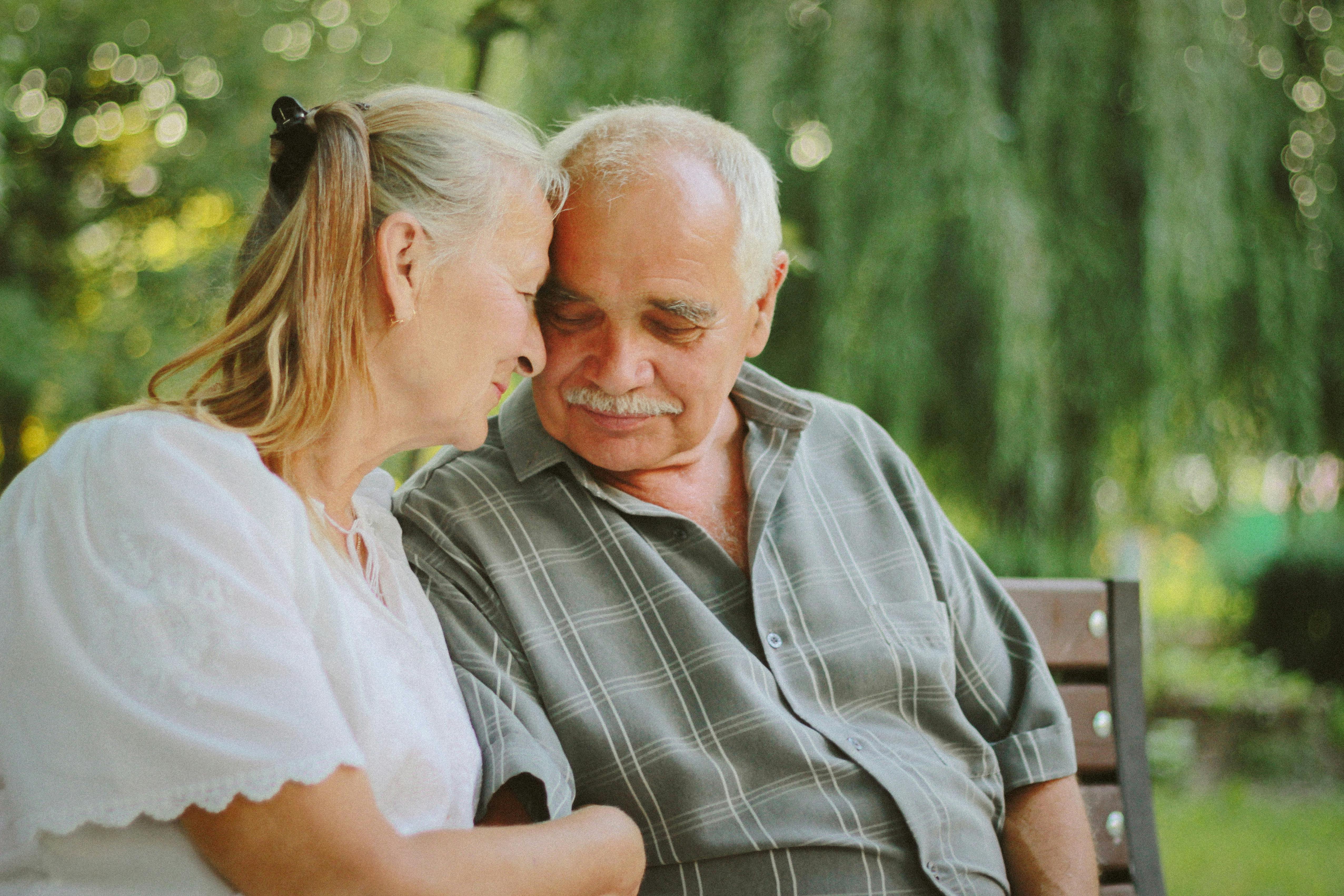 An older couple shares a quiet moment together while sitting on a park bench. | Source: Pexels
