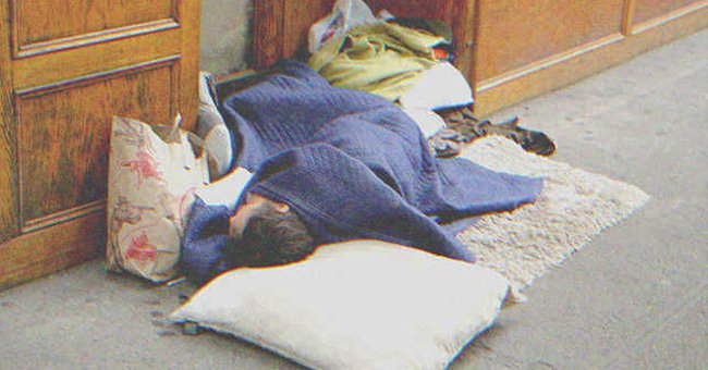 A homeless man sleeping on the street | Source: Shutterstock