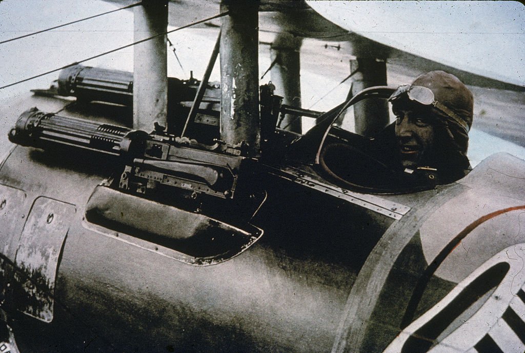 Rickenbacker sits in his Nieuport 28 fighter plane and smiles at the camera, 1910s | Source: Getty Images