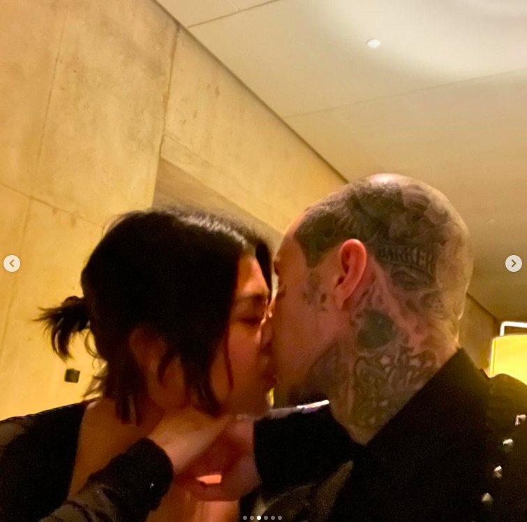 Kourtney Kardashian and Travis Barker sharing a kiss, posted on February 15, 2024 | Source: Instagram/travisbarker
