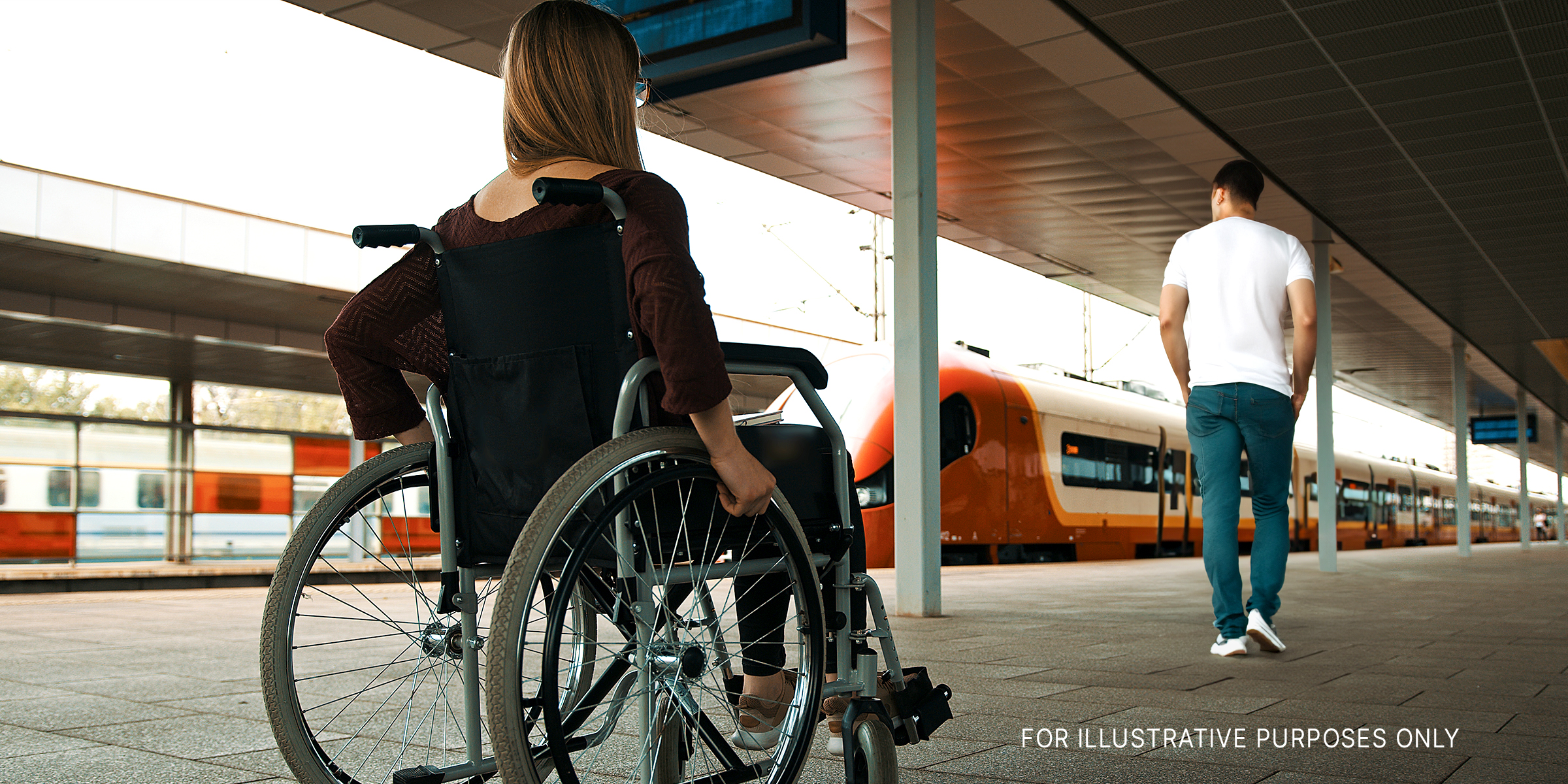 A man walking away from a woman in a wheelchair | Source: Shutterstock