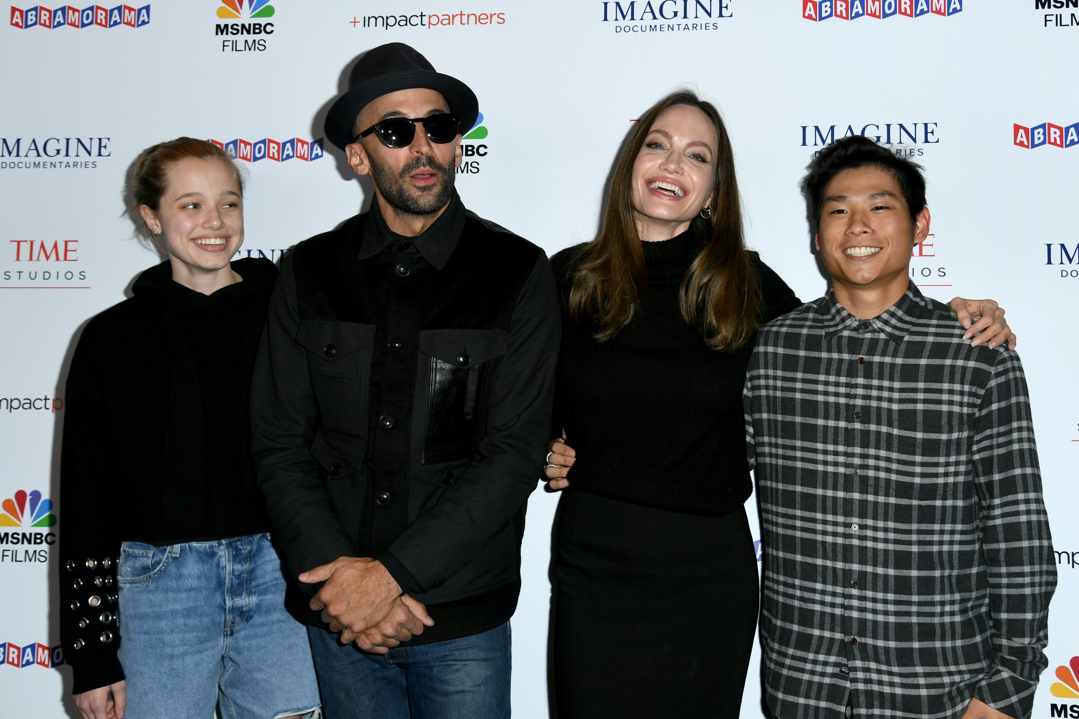 Shiloh Jolie-Pitt, street artist JR, actress Angelina Jolie and Pax Thien Jolie-Pitt attend the Los Angeles premiere of MSNBC Films' "Paper & Glue: A JR Project" at Museum Of Tolerance on November 18, 2021 in Los Angeles, California. | Source: Getty Images