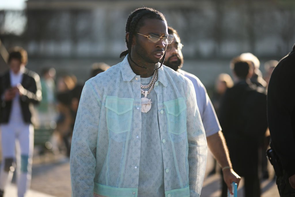 Pop Smoke is wearing a Louis Vuitton look before the Louis Vuitton AW20 Men Show on January 16, 2020. | Photo: Getty Images