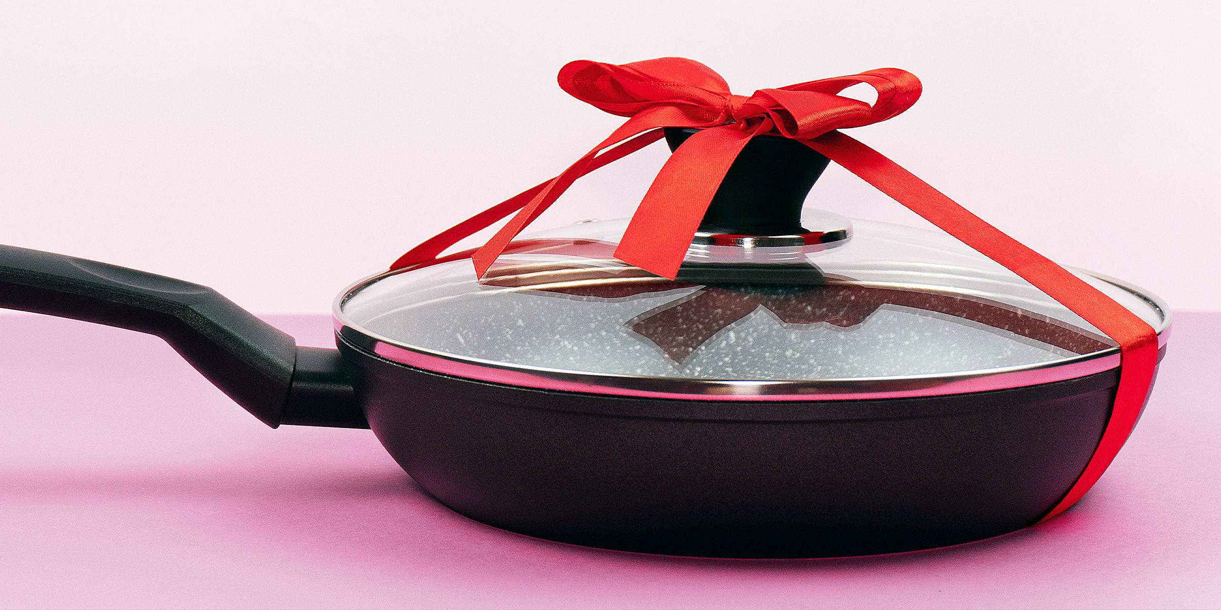A ribbon tied around a frying pan | Source: Shutterstock