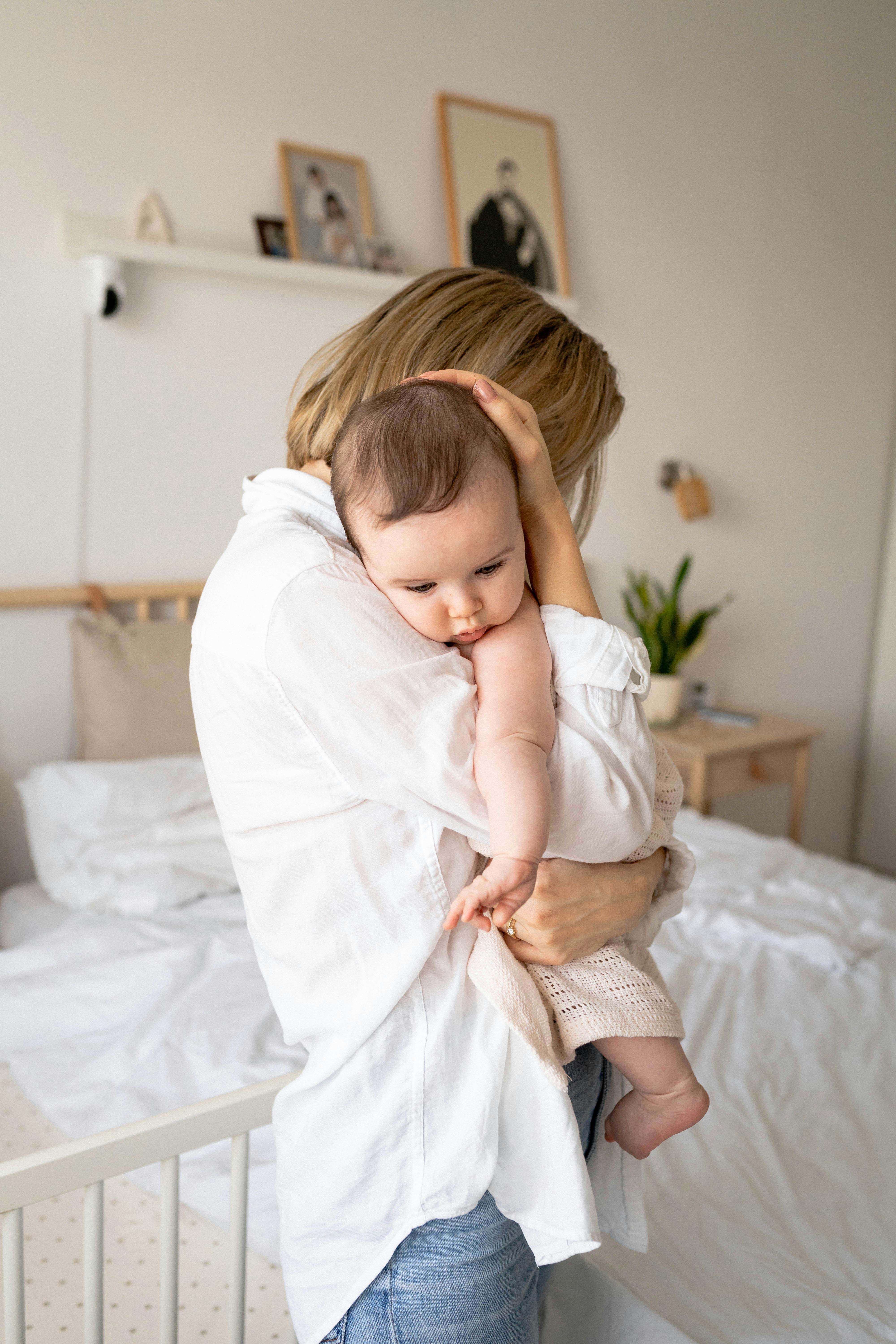 A woman hugging her baby | Source: Pexels