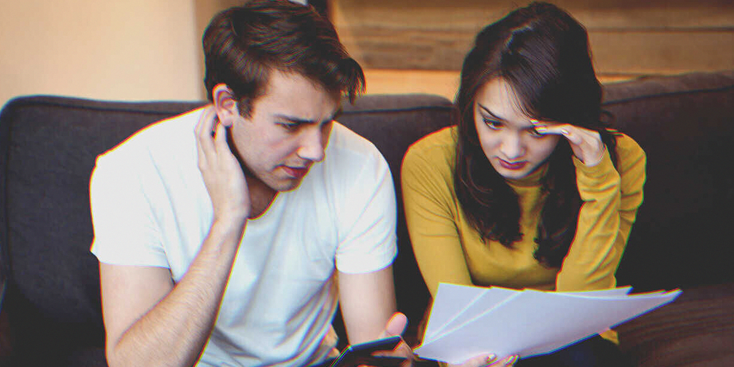 A photo of a couple looking anxiously at a document | Source: Freepik