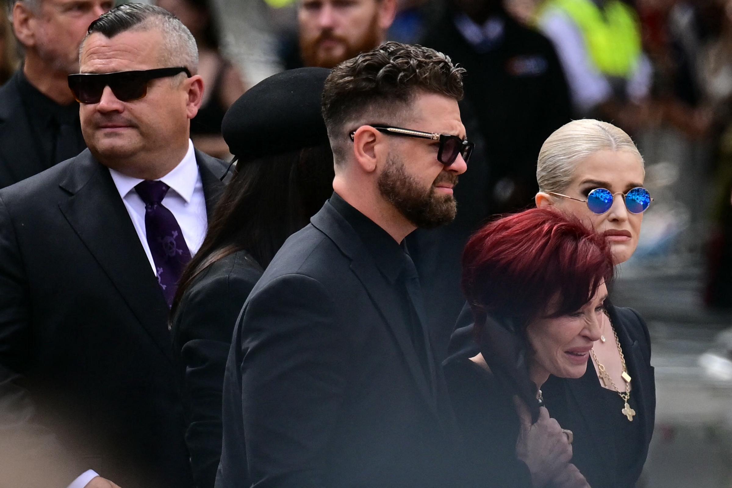 Ozzy Osbourne's family - Louis, Aimee, Jack, Sharon and Kelly arrive at the tribute site for the late rockstar at the Black Sabbath, in Birmingham, England on July 30, 2025 | Source: Getty Images