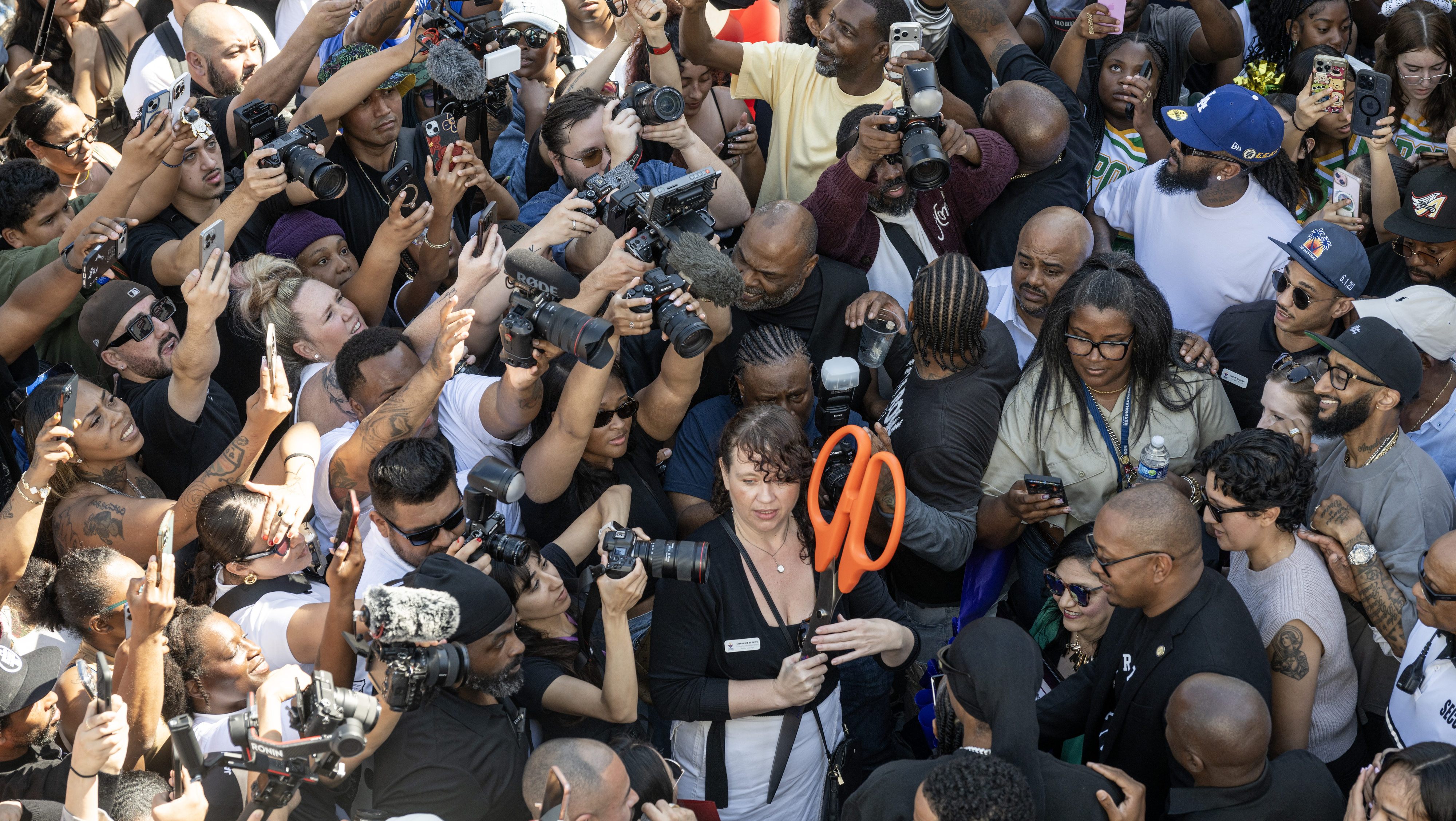 Long Beach residents gather around Blacc Sam and Snoop Dogg before a ribbon-cutting ceremony celebrating the new Marathon Burger restaurant in downtown Long Beach on Sunday, March 1, 2026 | Source: Getty Images
