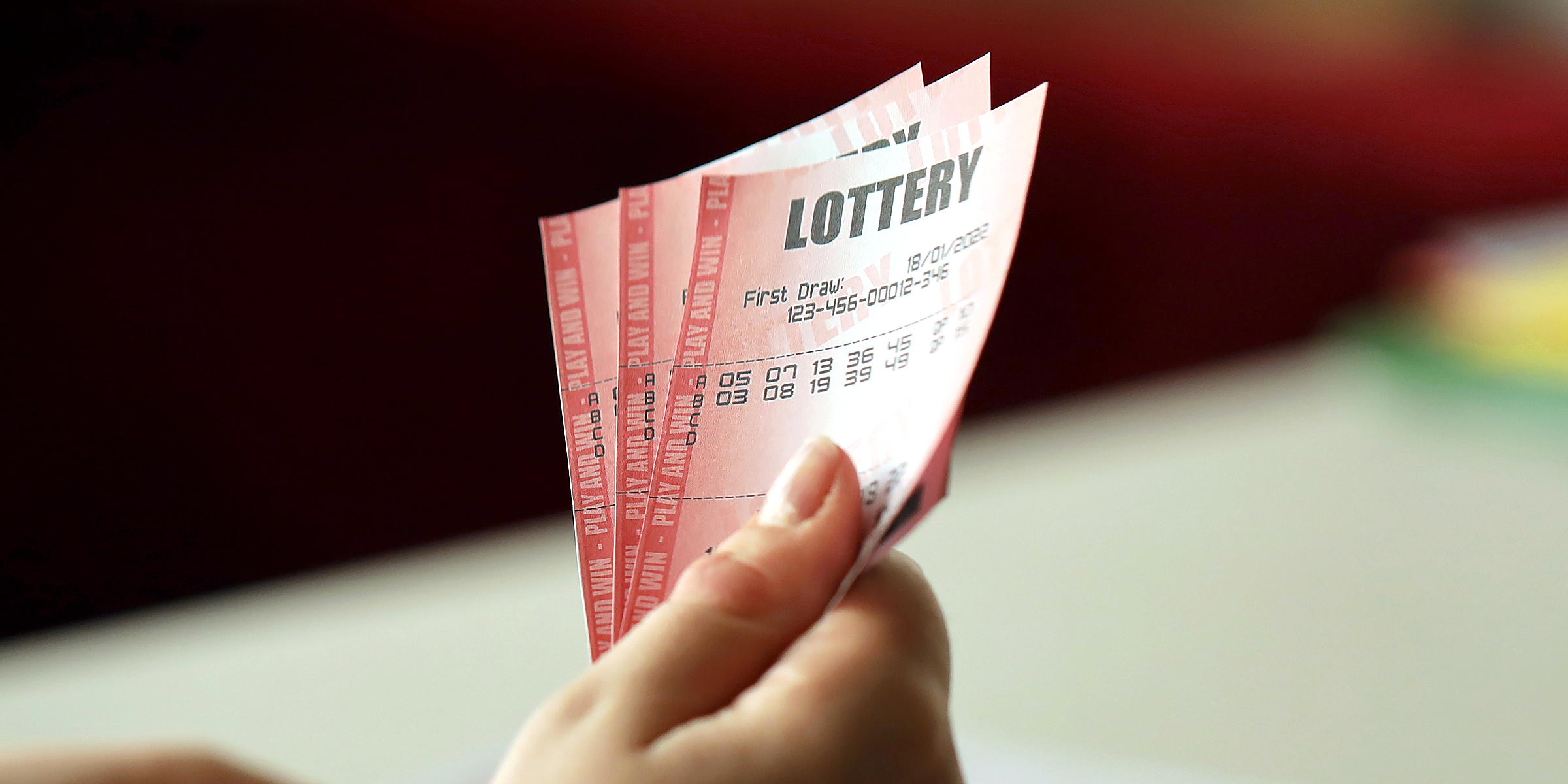 A person holding three lottery tickets | Source: Shutterstock