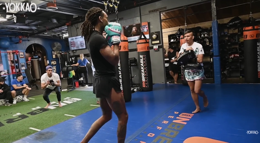 Wiz Khalifa prepares for pad work under the guidance of Superlek Kiatmoo9 at Unbreakable Gym in Los Angeles. | Source: YouTube/YOKKAO