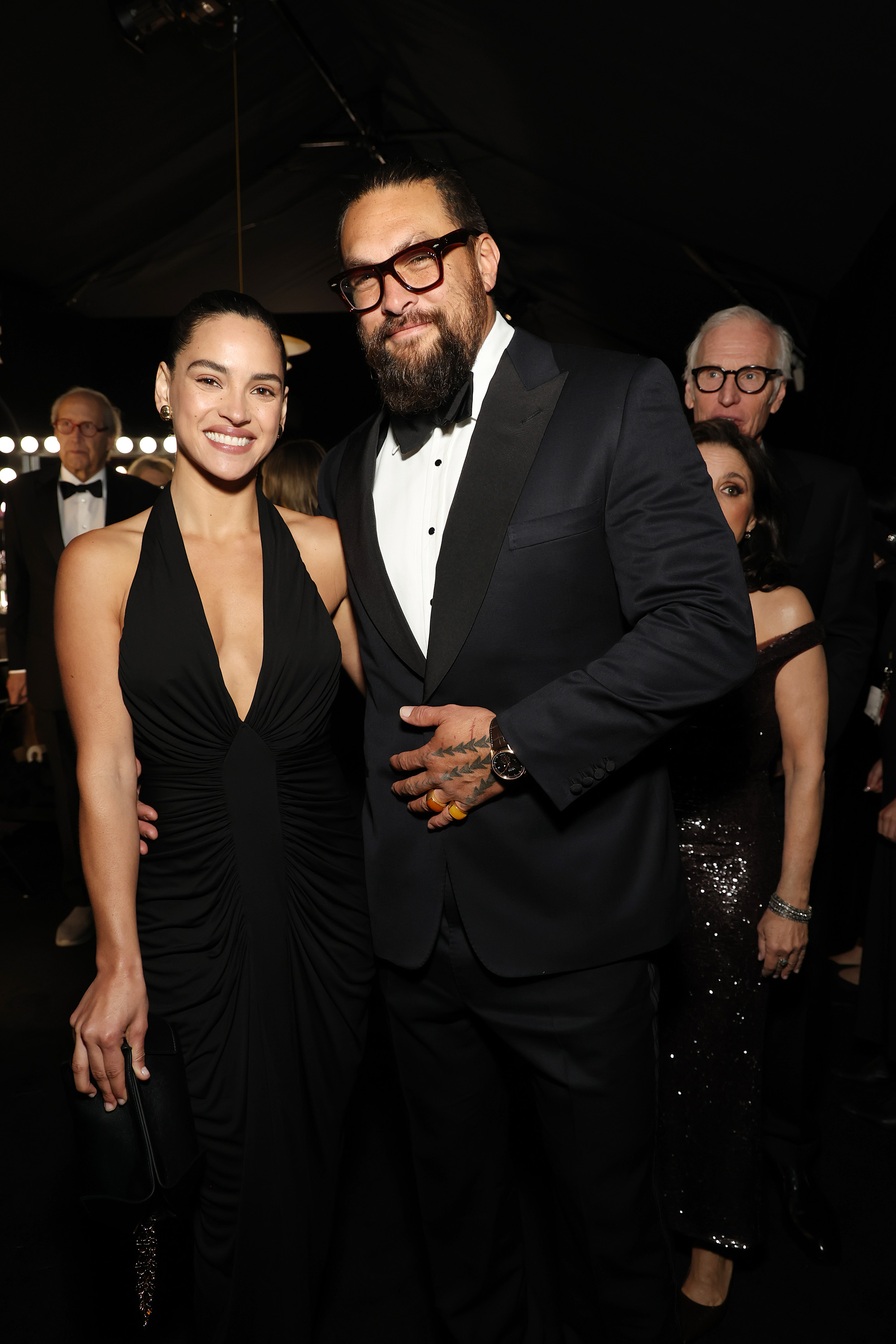 Adria Arjona and Jason Momoa smiling for the cameras. | Source: Getty Images