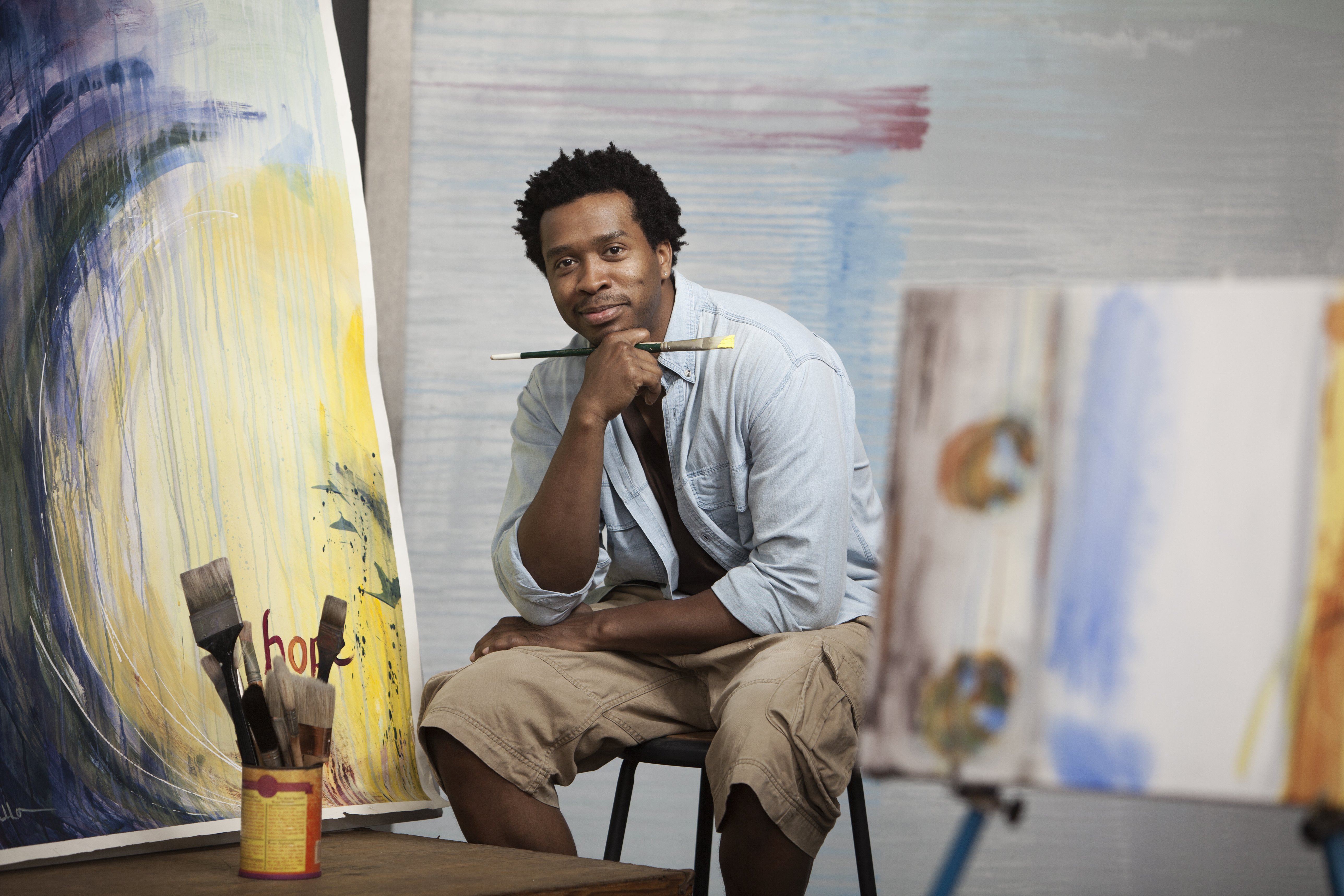 A black Artist sitting in studio as he poses for a photo | Photo: Getty Images