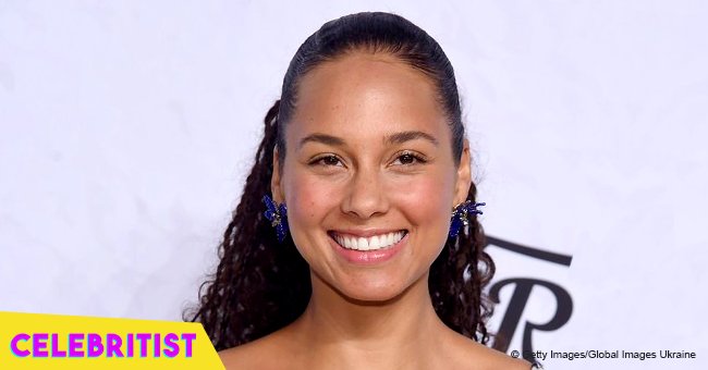 Alicia Keys stuns in floral top and mini shorts, posing next to luxurious black car