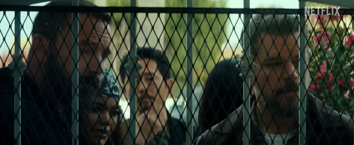 Ben Affleck, Teyana Taylor, Steven Yeun, and Matt Damon appear behind a security gate during an investigation scene in "The Rip" | Source: YouTube/Netflix