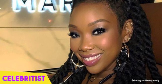 Brandy's daughter flaunts her new hairstyle while wearing bright red blouse & big earrings in pic