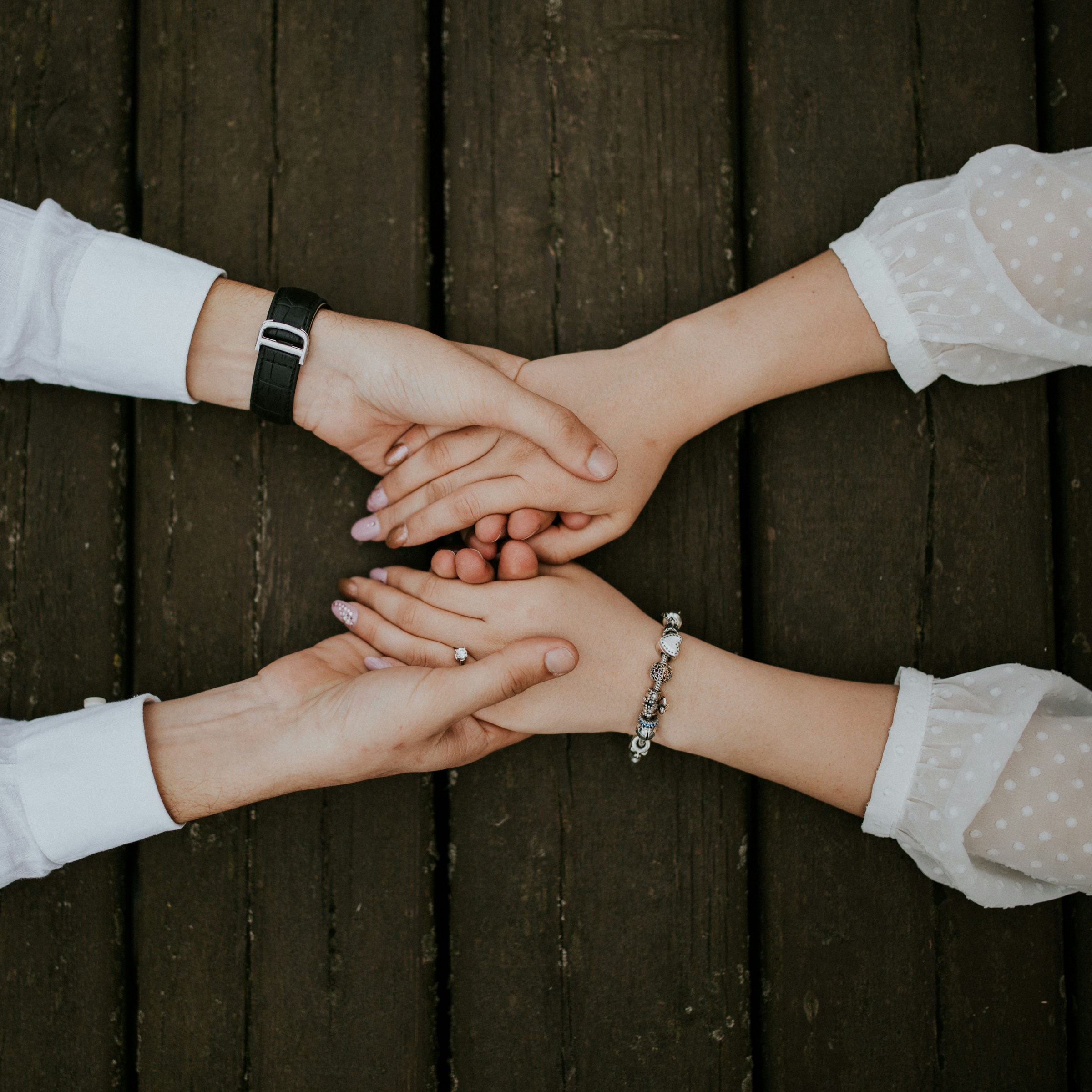 Holding hands across a table | Source: Unsplash