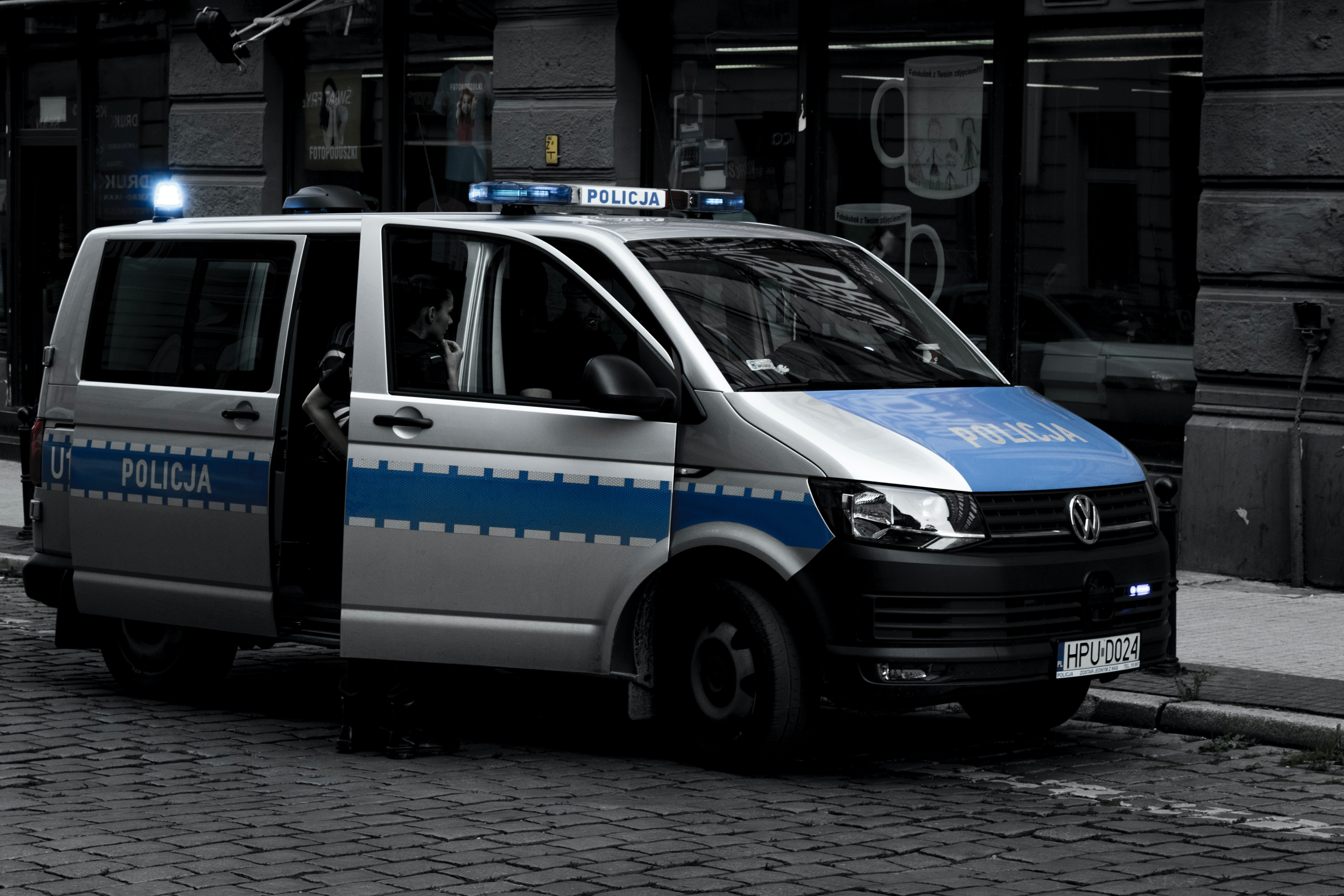 Pictured - A gray police Volkswagen van parked on the sidewalk | Source: Pexels 