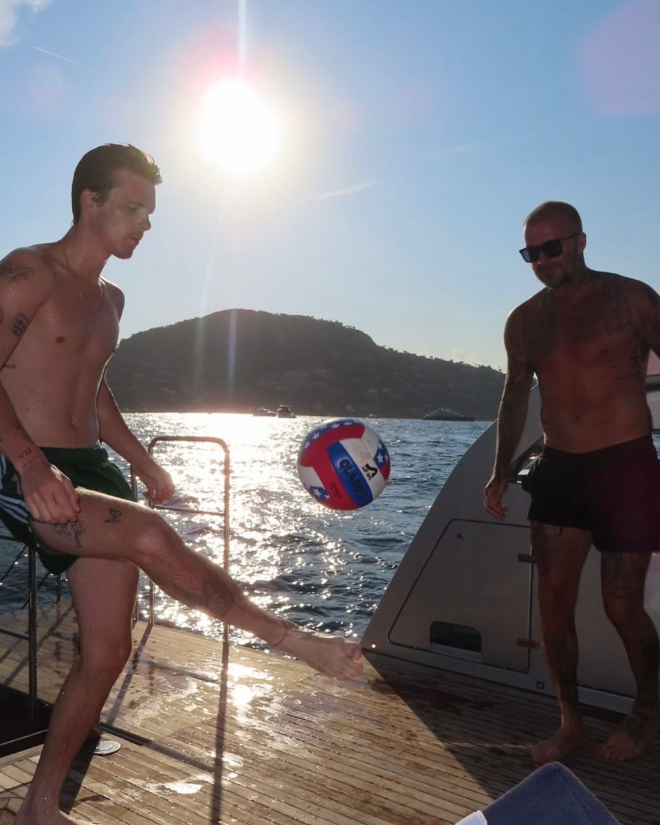 Cruz and David Beckham playing with a soccer bal on a yacht, from Victoria Beckham's vacation post dated August 10, 2025 | Source: Instagram/victoriabeckham