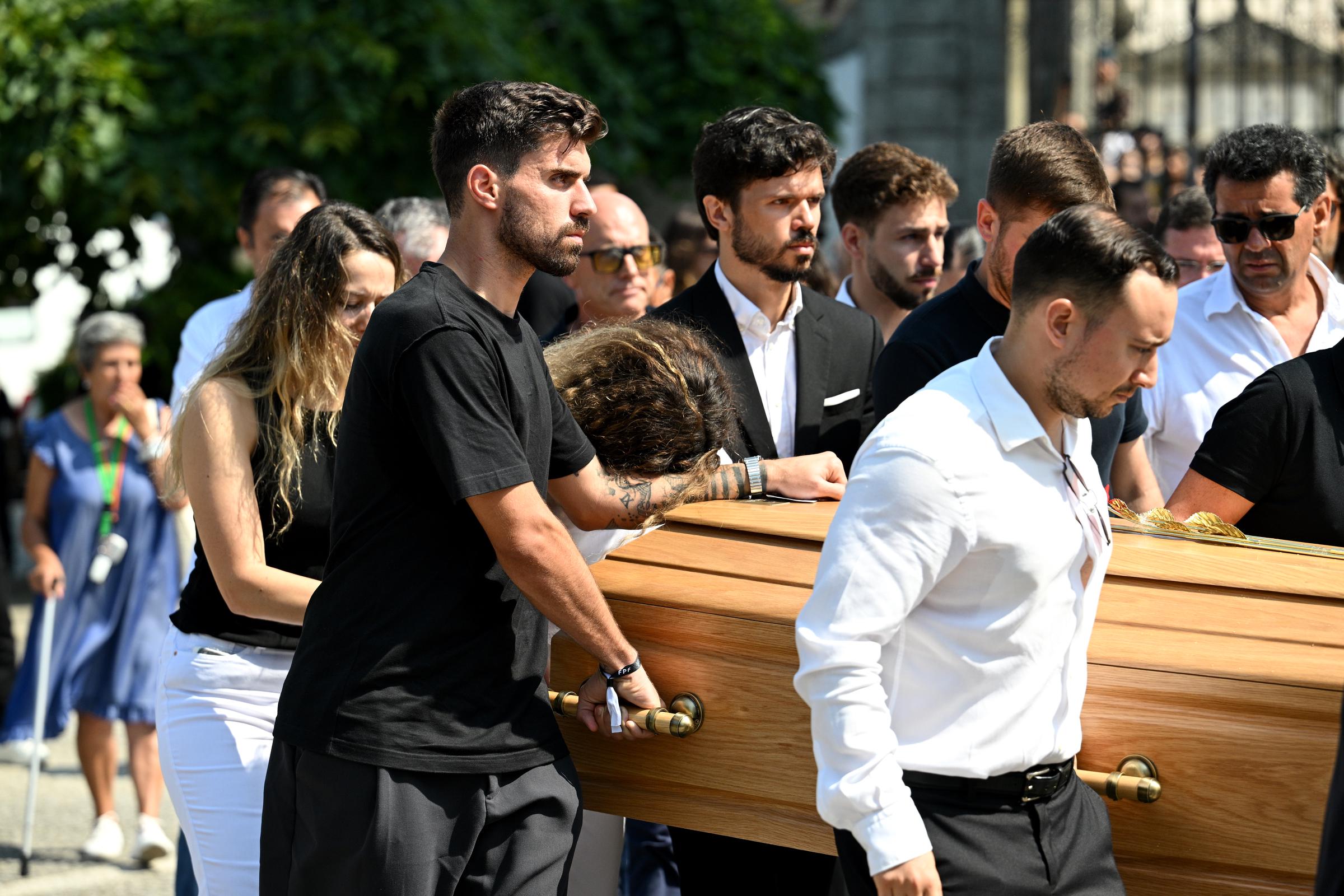 Rute Cardoso leans on the arm of Ruben Neves as he helps carry Diogo Jota's coffin following the funeral service | Source: Getty Images