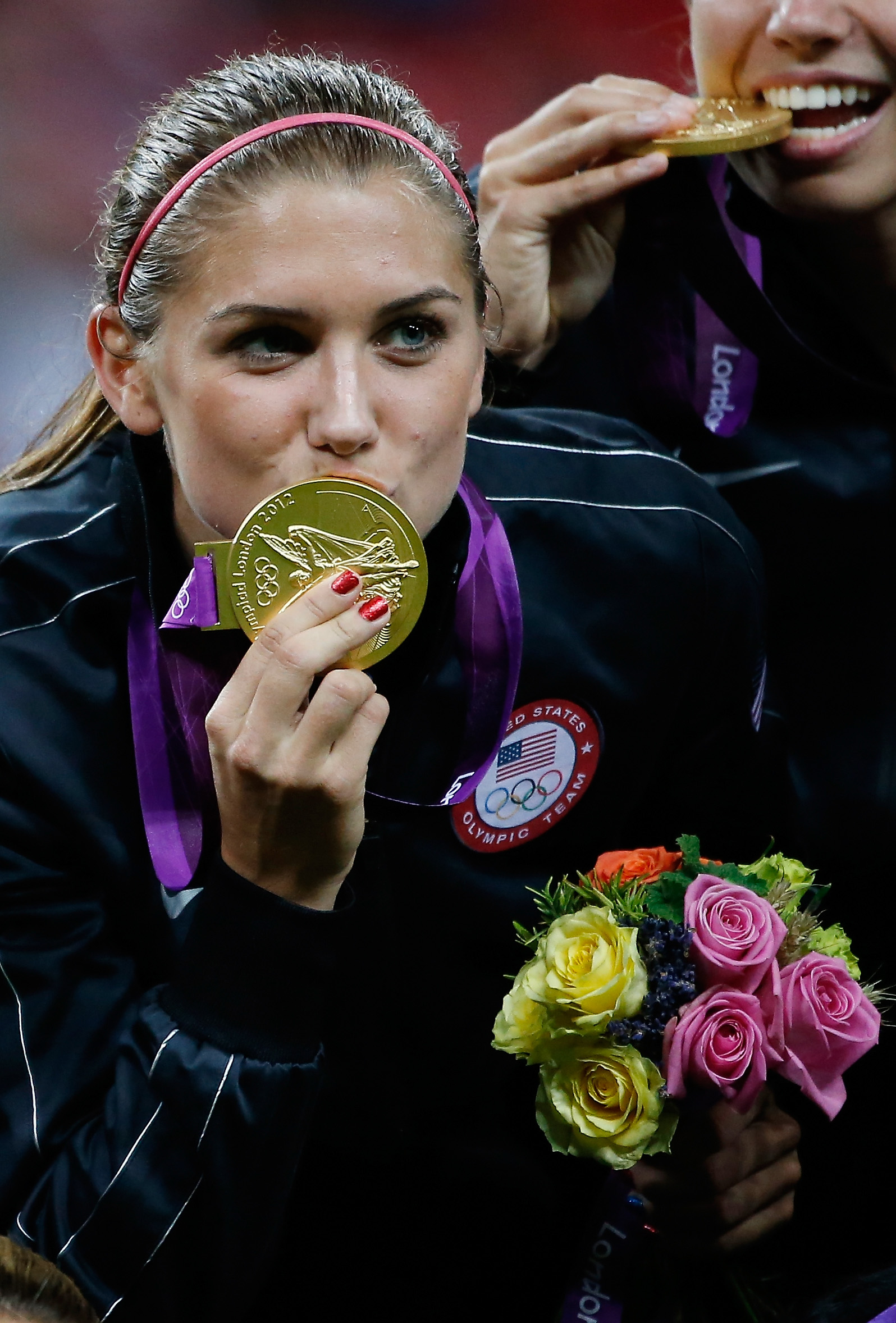 Alex Morgan kisses the gold medal after defeating Japan by a score of 2-1 to win the Women's Football gold medal match at the London 2012 Olympic Games in London, England, on August 9, 2012. | Source: Getty Images